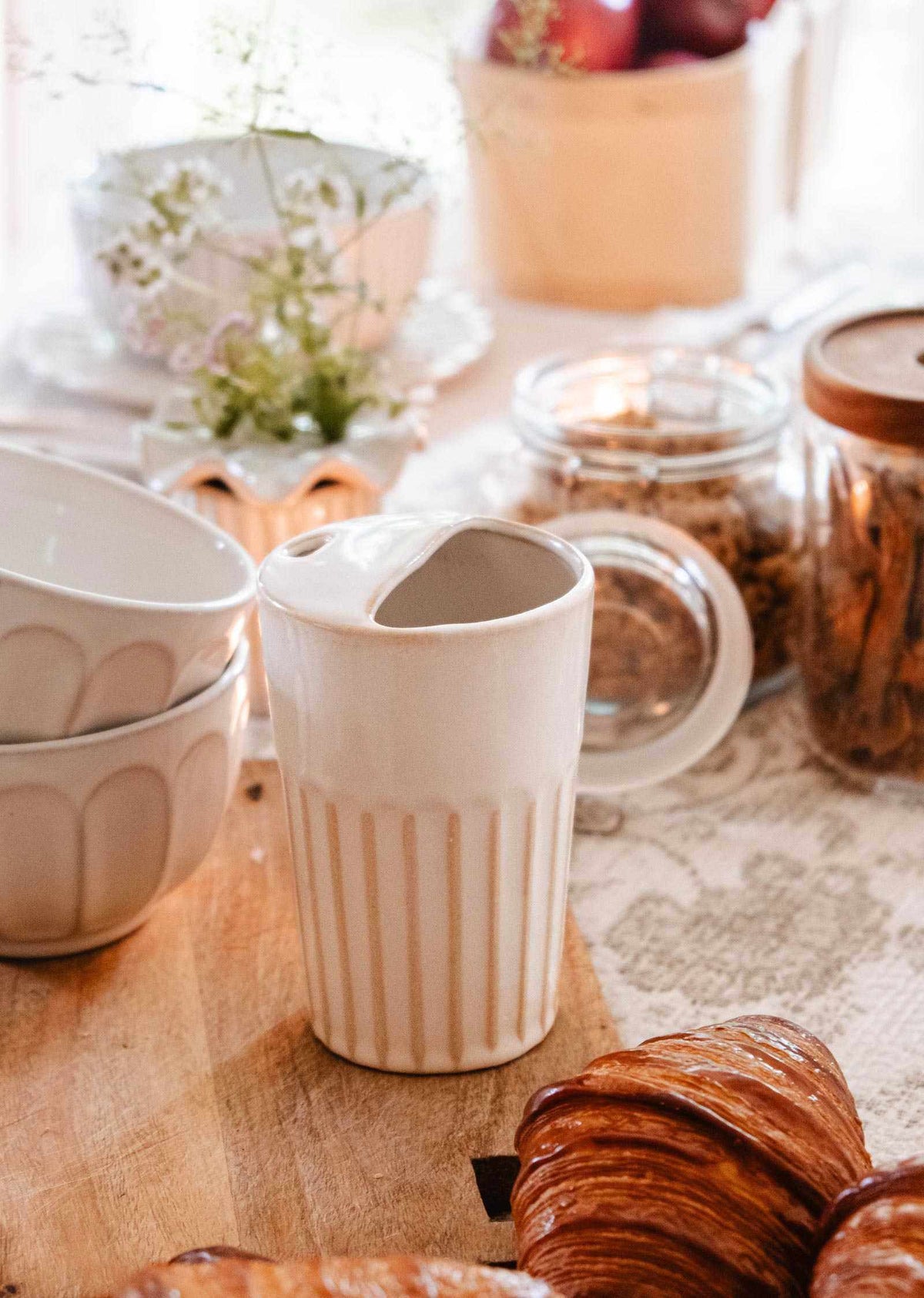 Handmade ceramic to-go cup with ribbed grip and fitted lid