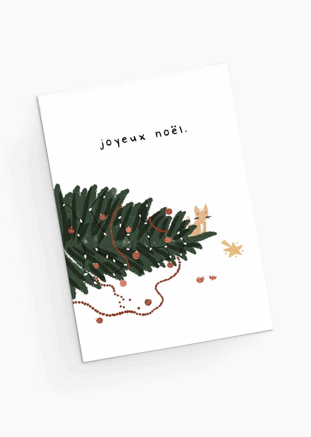 Fallen Christmas tree with a small kitten and ornaments. By Mimi & August