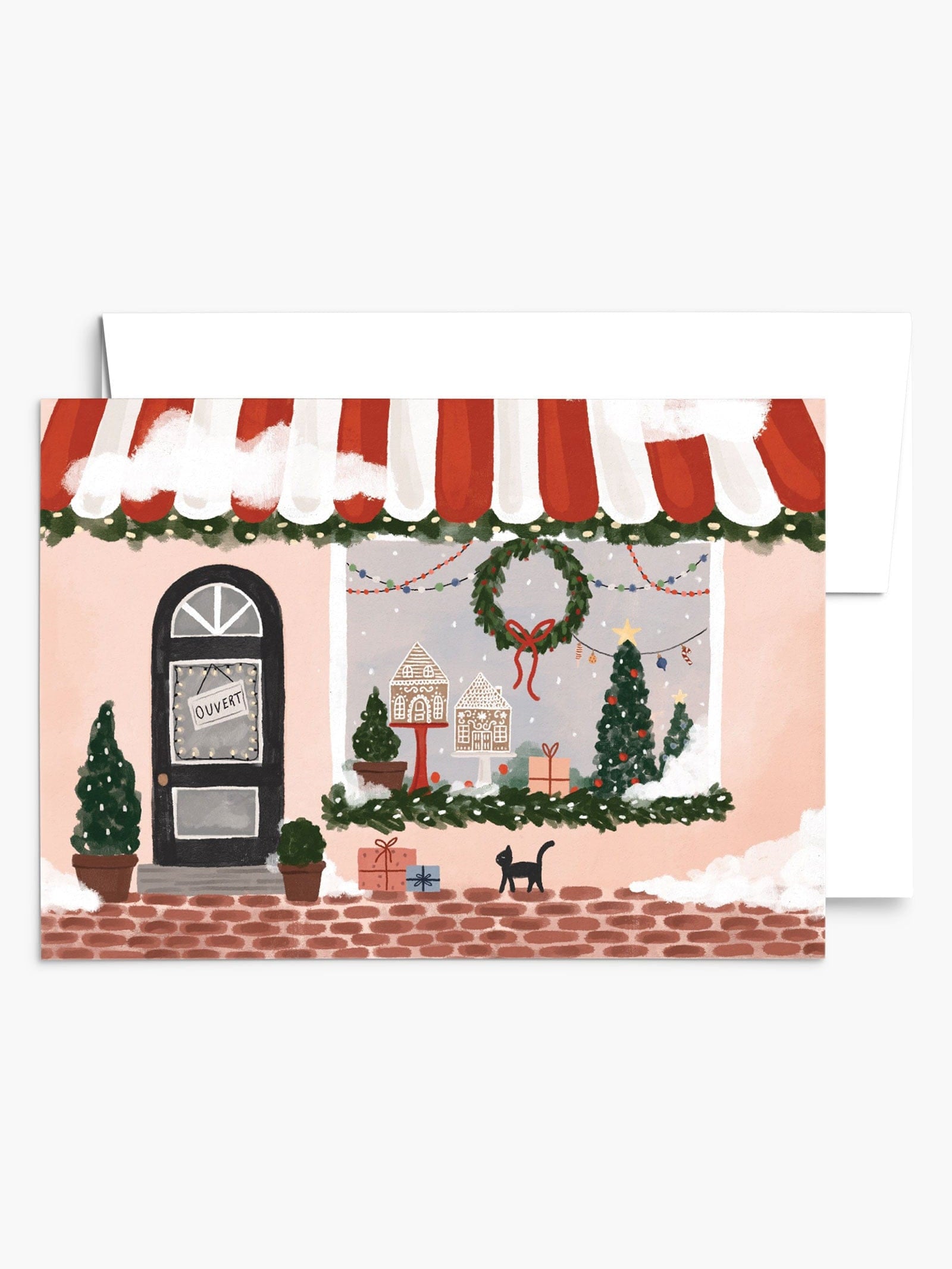 cute Christmas boutique storefront greeting card, featuring snowflakes, window with tree, gingerbread houses and a wreath. By mimi & august