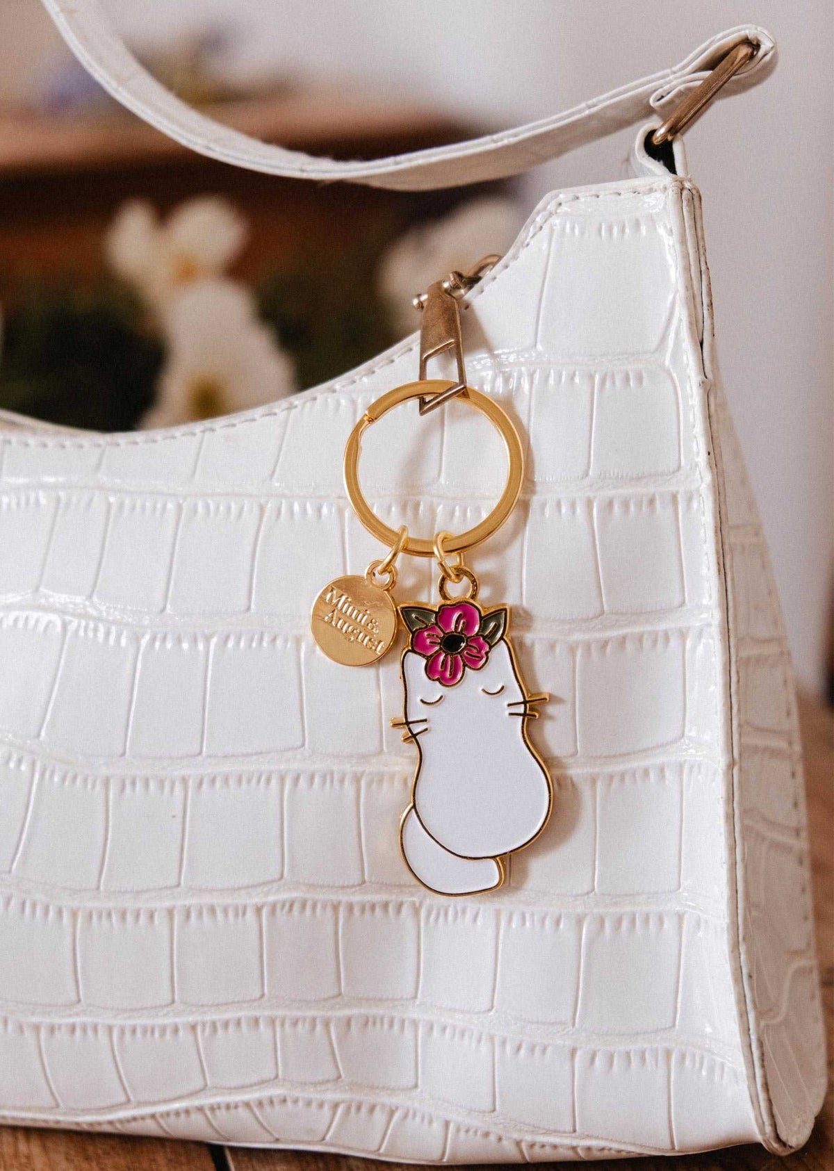 Floral cat keychain with pink flower and gold brass finish