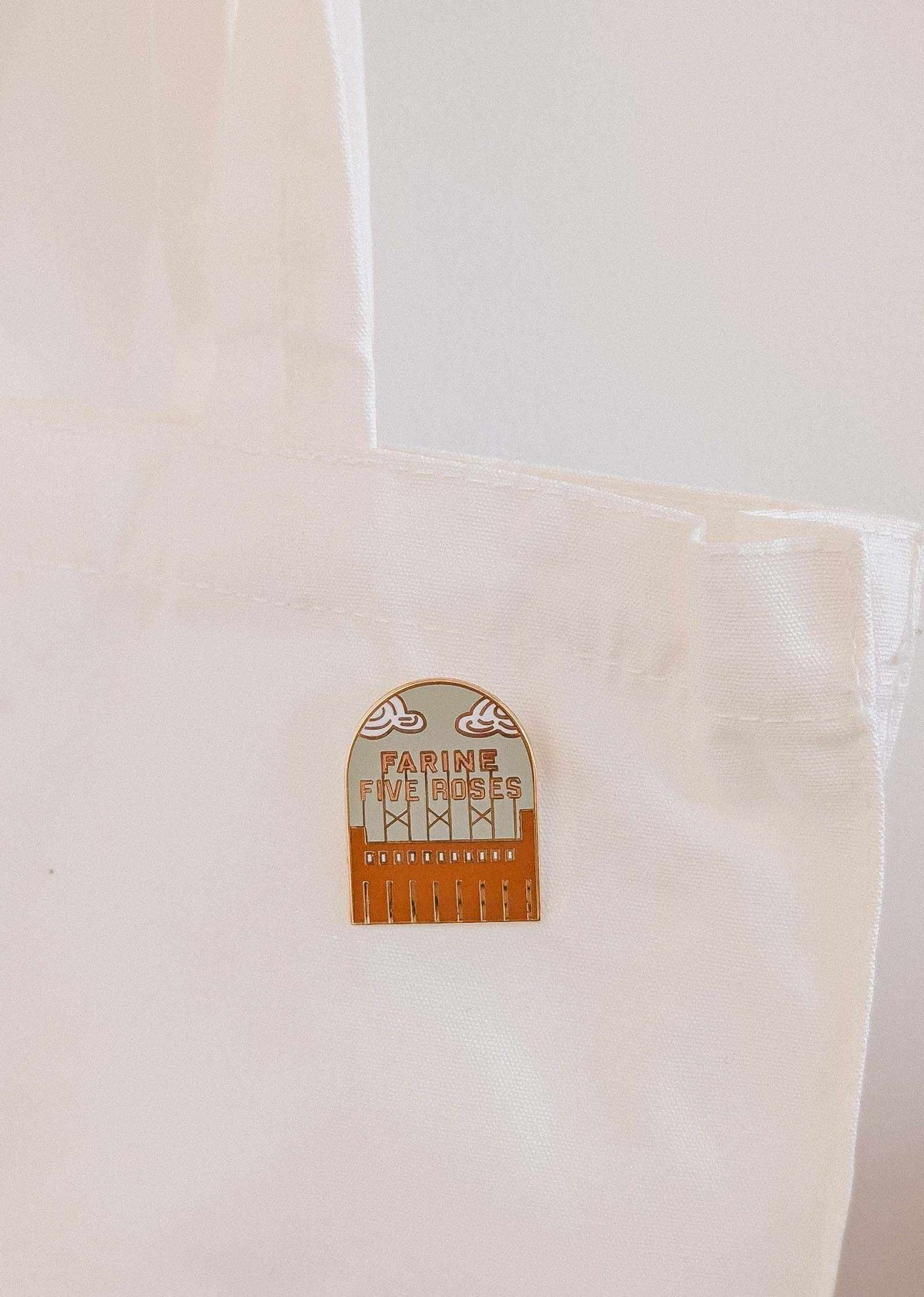 Flour & Roses Factory enamel pin with retro Montreal skyline design