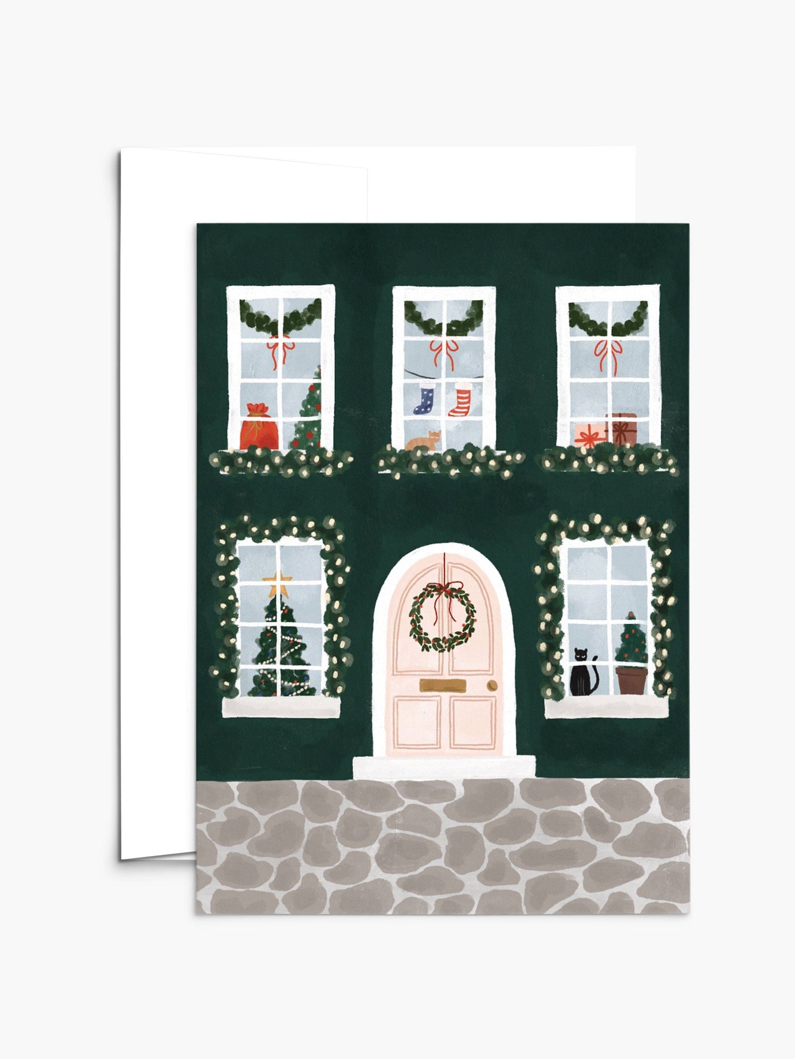 Greeting card with green holiday home with windows showing kitties, Christmas's socks and tree. By Mimi & August