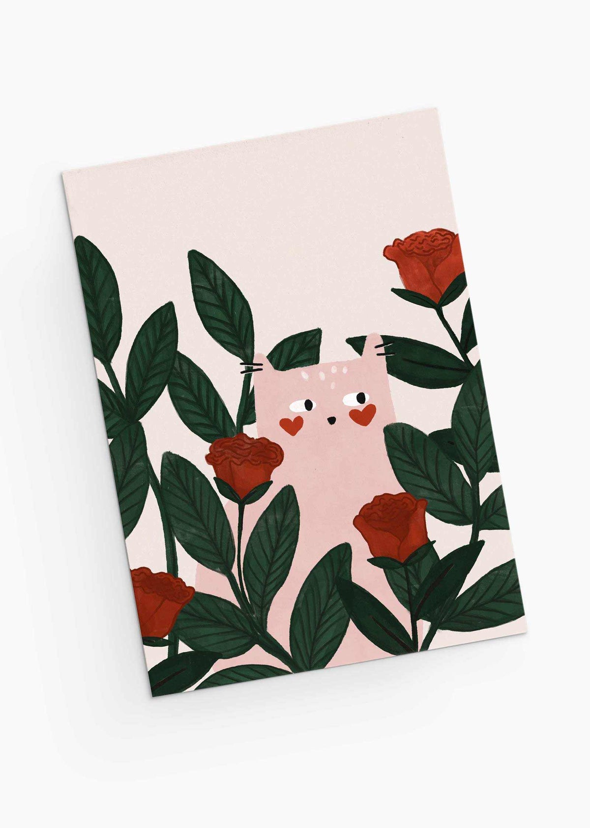 The Lovey Dovey Cat Greeting Card by Mimi & August features a cat with heart-shaped cheeks among green leaves and red roses, ideal for a Valentine's Day greeting on a crisp white background.