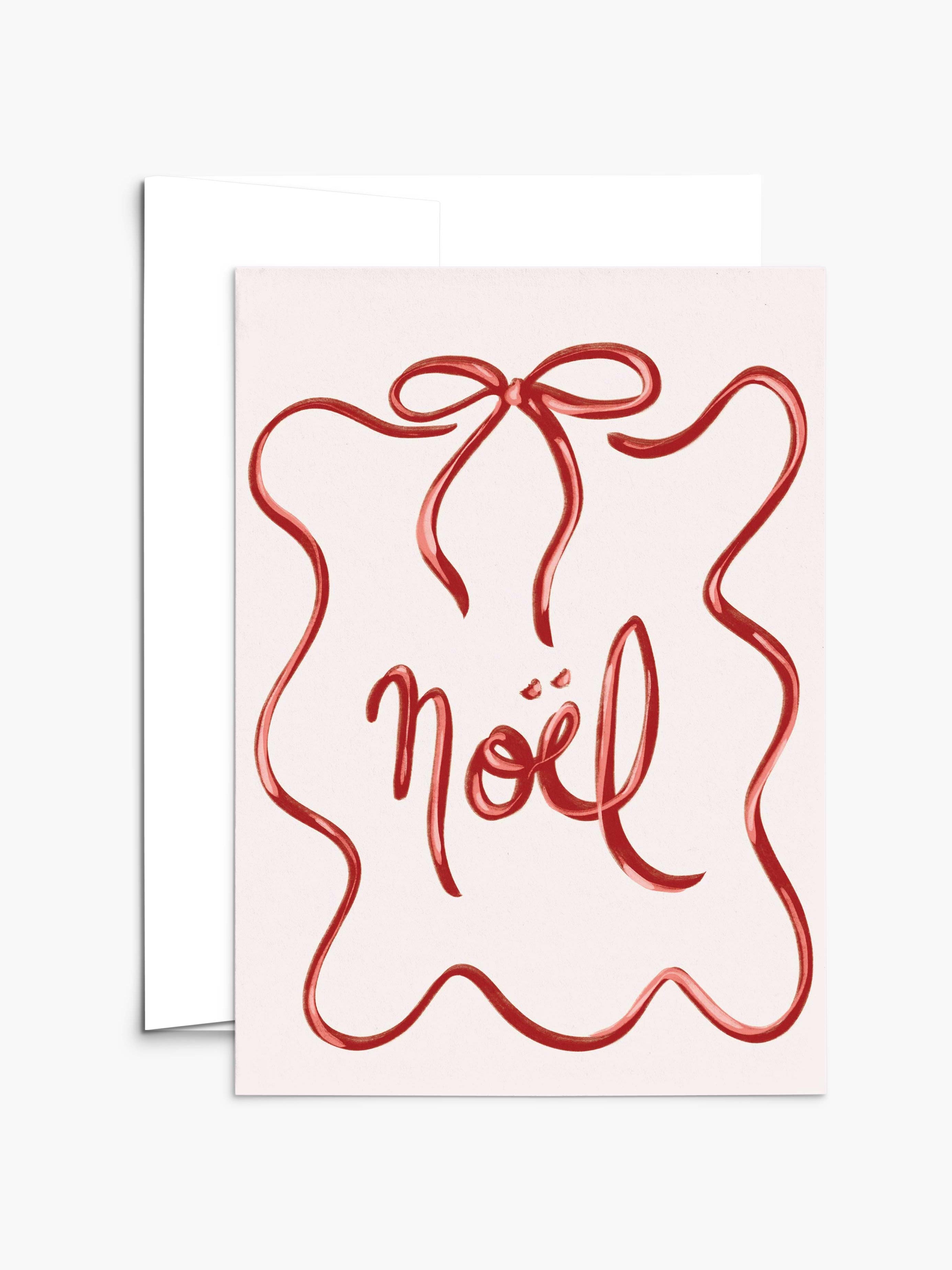 The Mimi & August Christmas Bow Greeting Card features a red ribbon design and “noël” in cursive, comes with a white envelope, and is printed on recycled paper. The card is blank inside for your personal message.