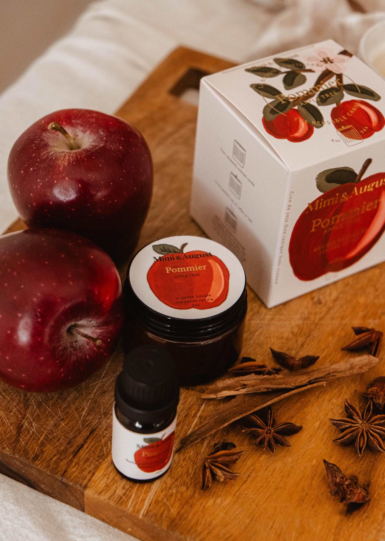 2 oz apple cinnamon candle in glass jar with warm autumn scent