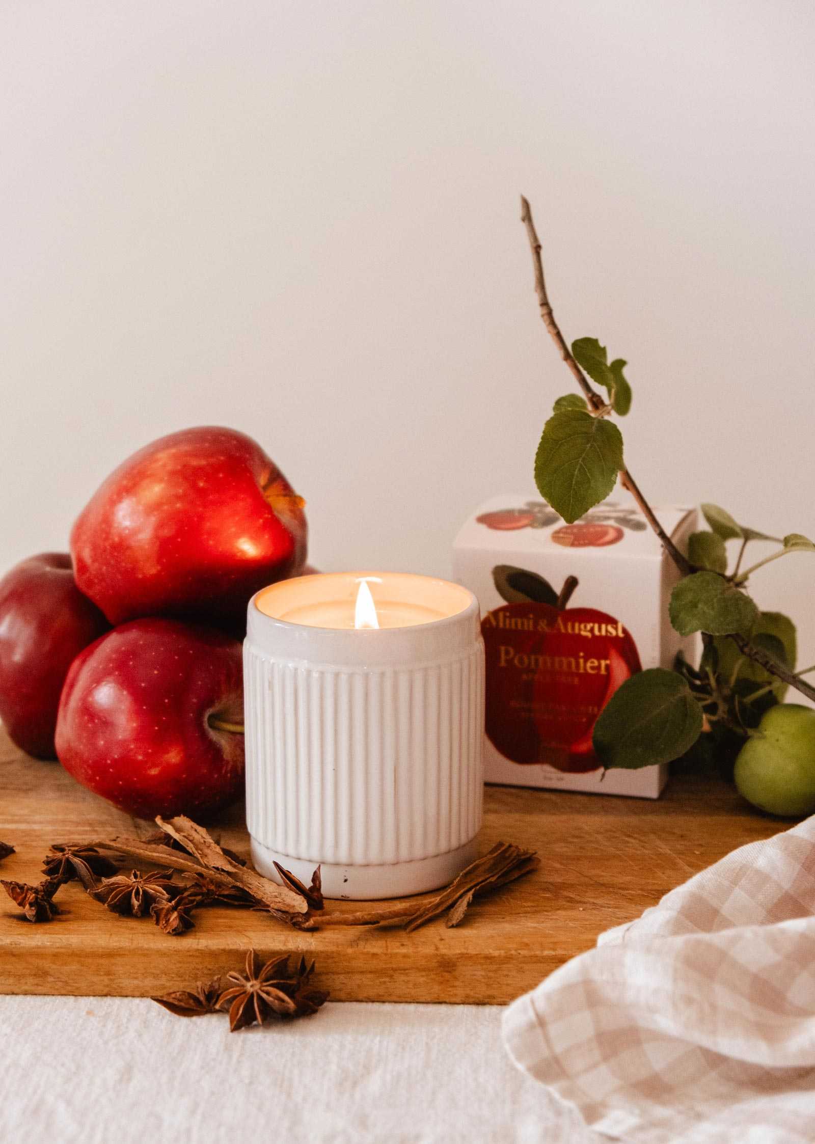 Reusable apple cinnamon soy candle in ceramic cup with autumn scent