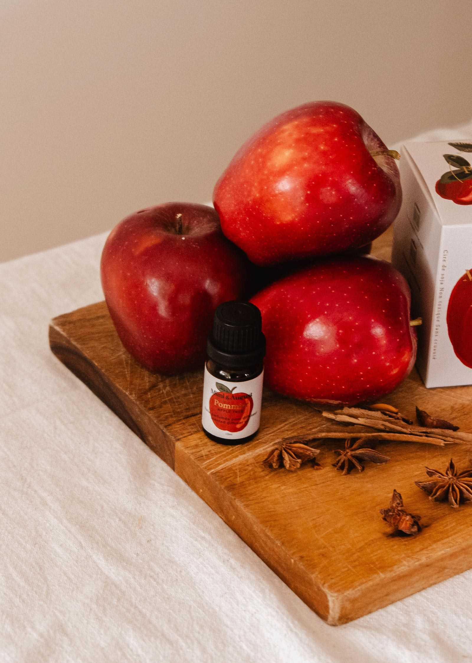 Bottle of apple cinnamon scented oil with autumn-themed label and diffuser accessories