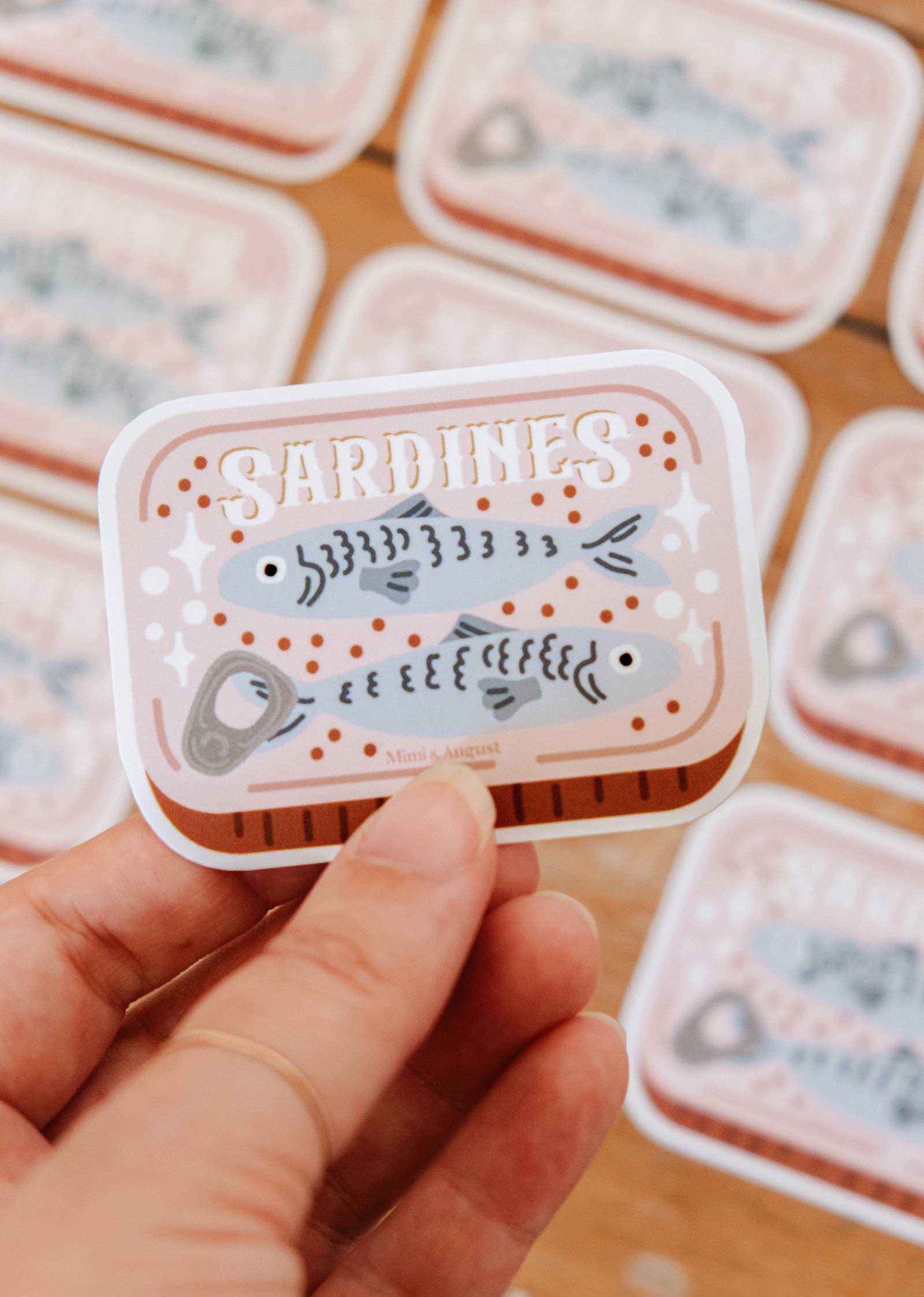 Cozy Sardines vinyl sticker of cute sardines stacked inside tin with matte finish and white border