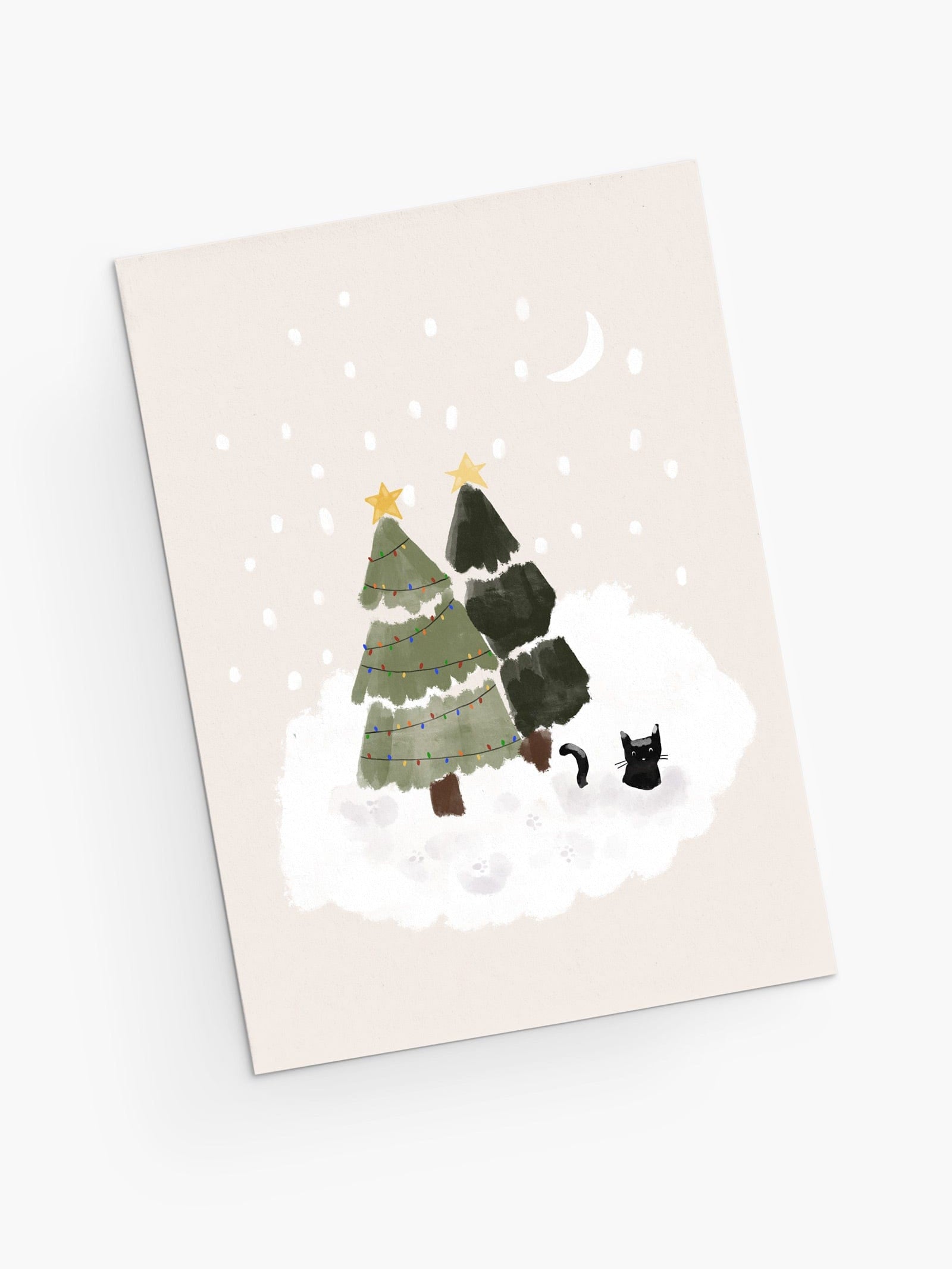 Holiday greeting card with christmas trees featuring a snowy cat under the trees. By Mimi & August