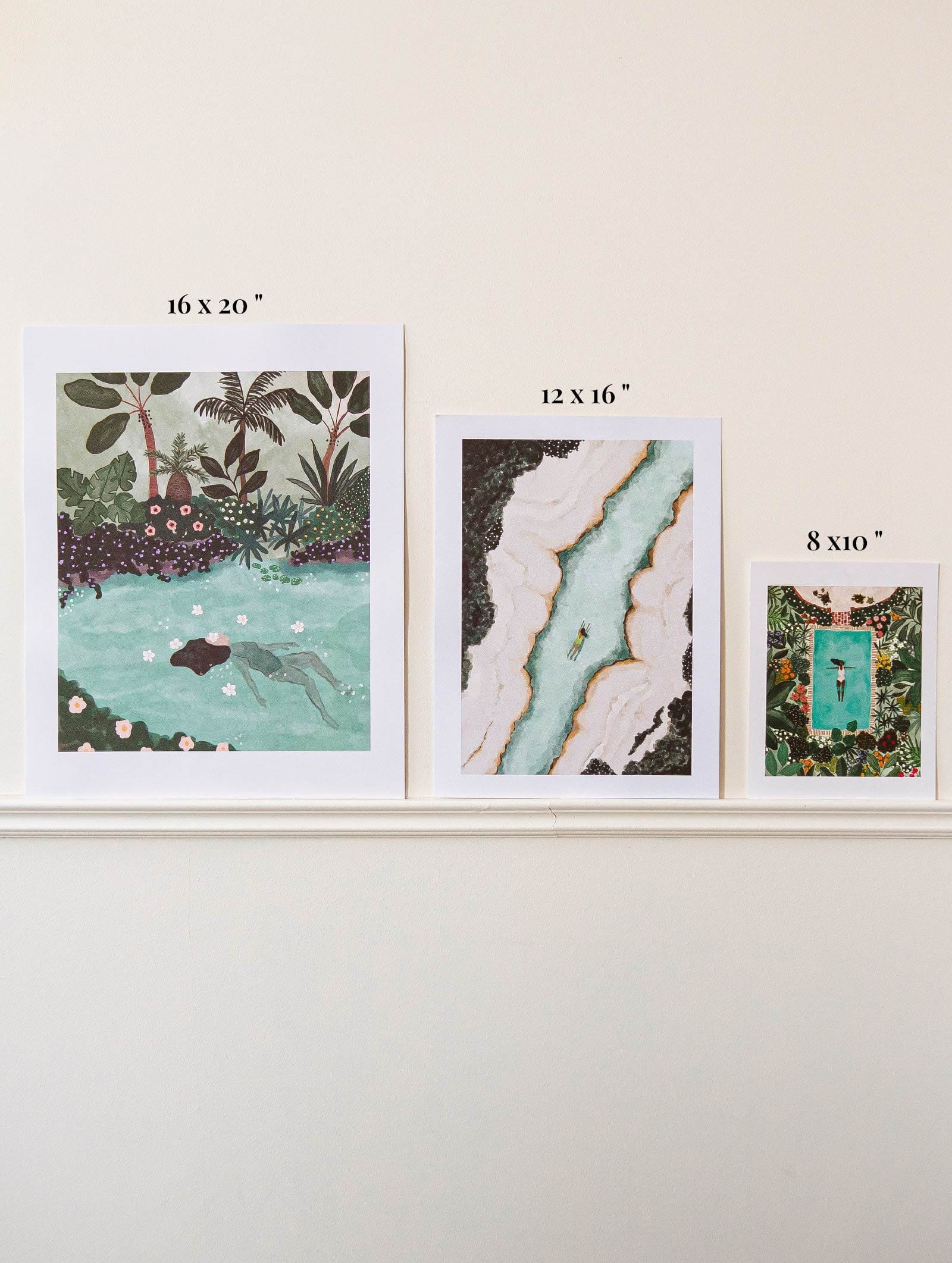 A set of four Swimming with Tigers Art Prints by Mimi & August on a Montreal wall featuring an eco-friendly pond image.