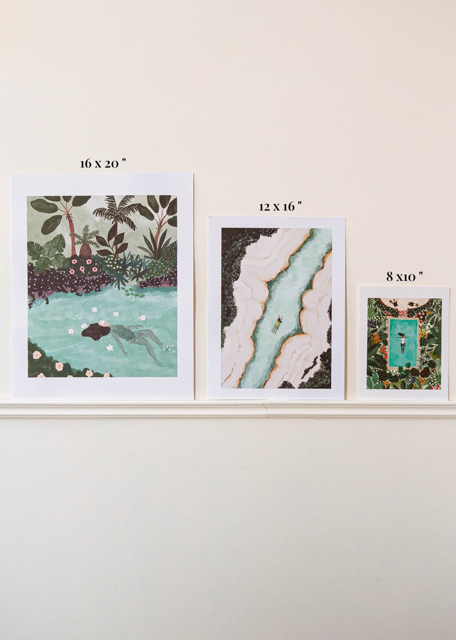 A set of four Swimming with Tigers Art Prints by Mimi & August on a Montreal wall featuring an eco-friendly pond image.