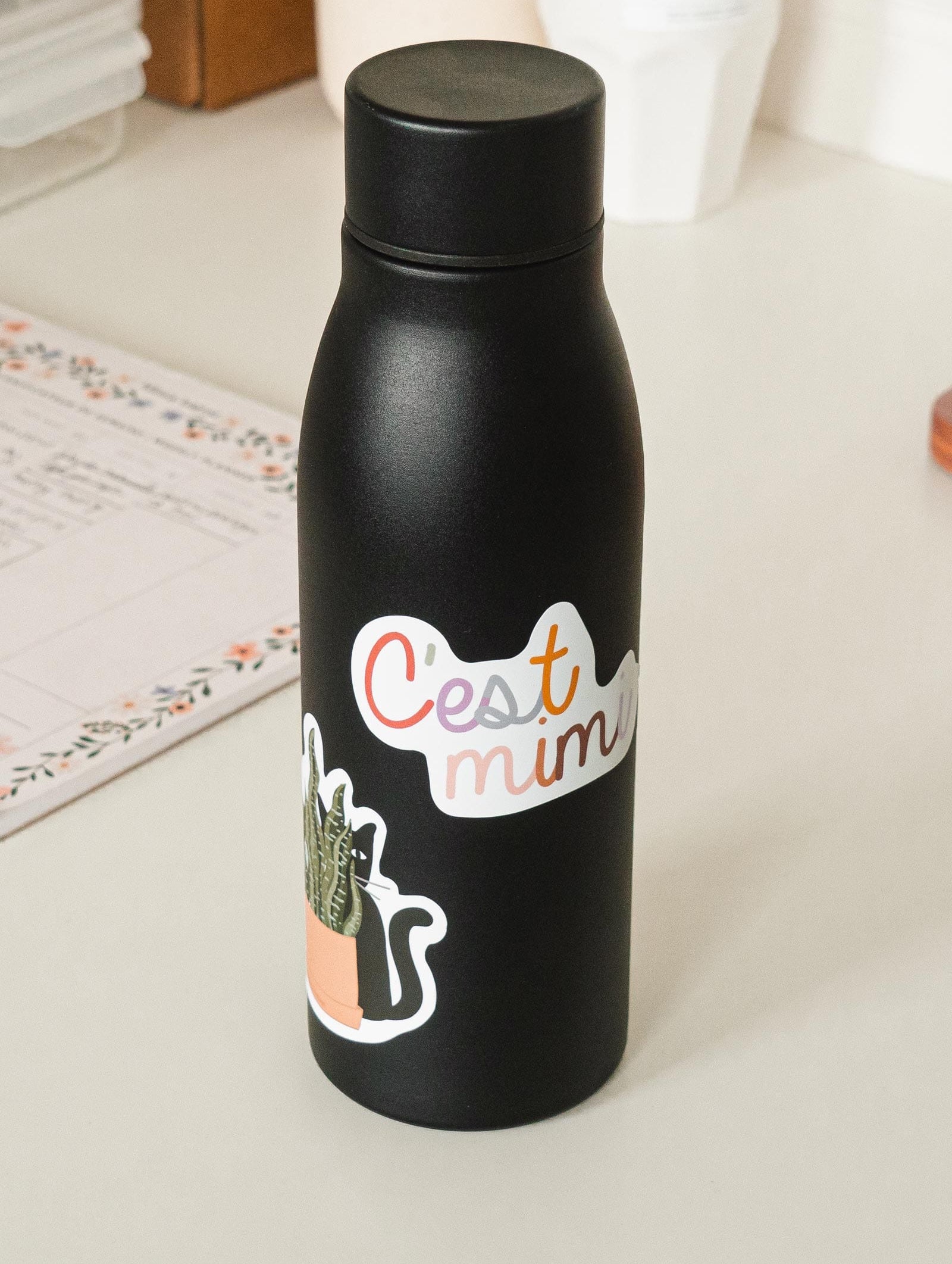 black water bottle with c'est mimi sticker