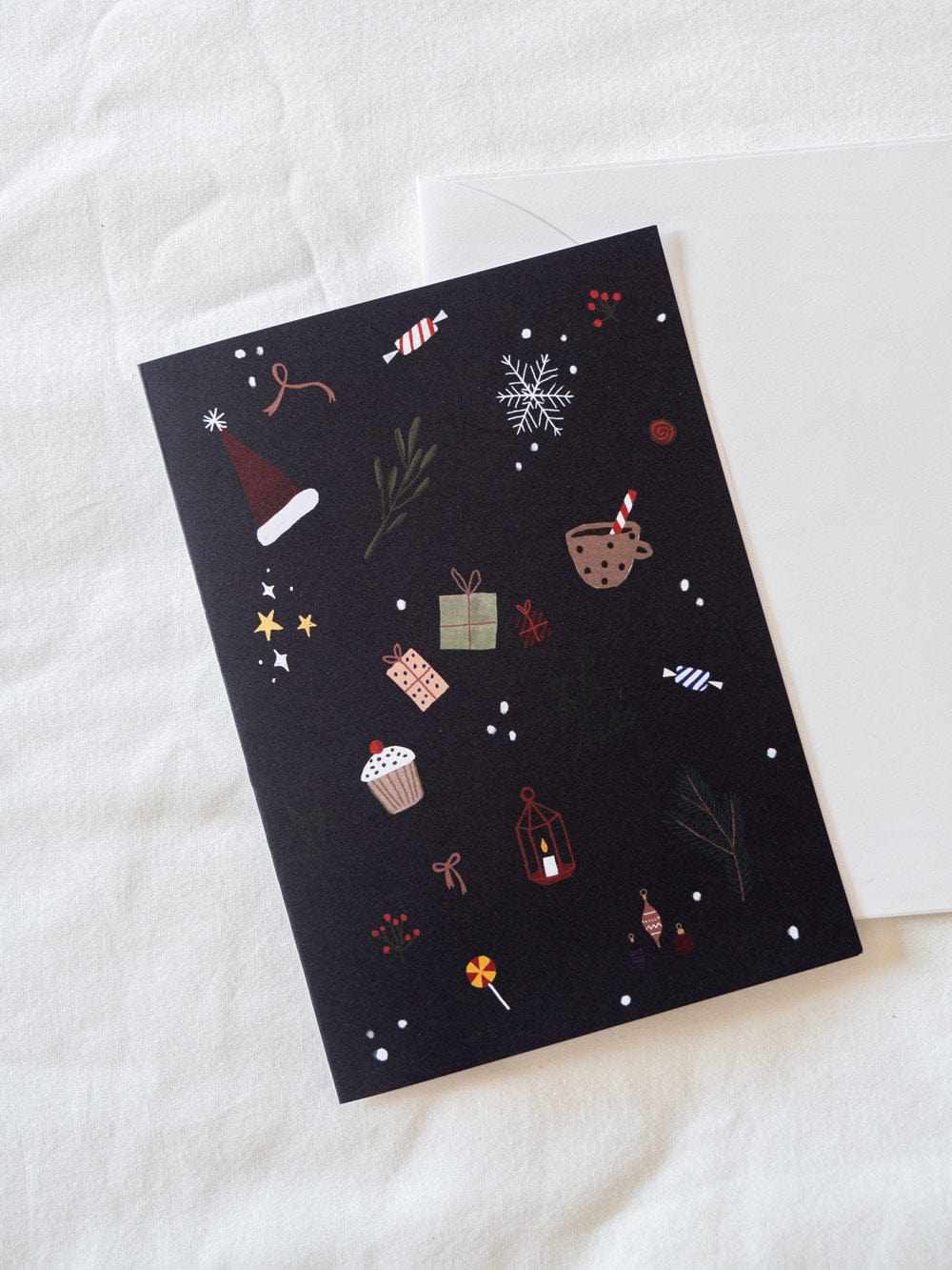 Christmas Spirit greeting card with festive icons on black recycled paper and white envelope