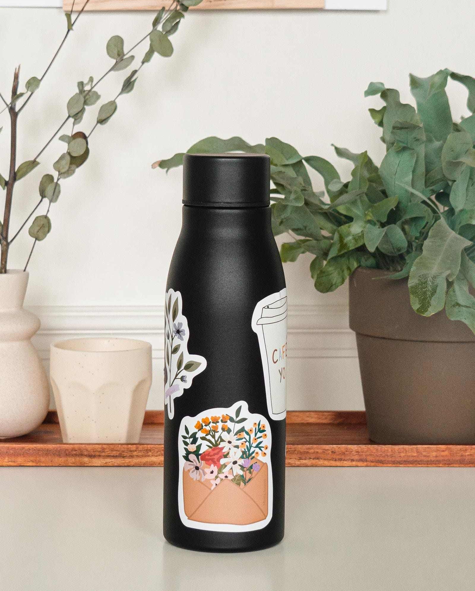 black water bottle with colorful floral sticker