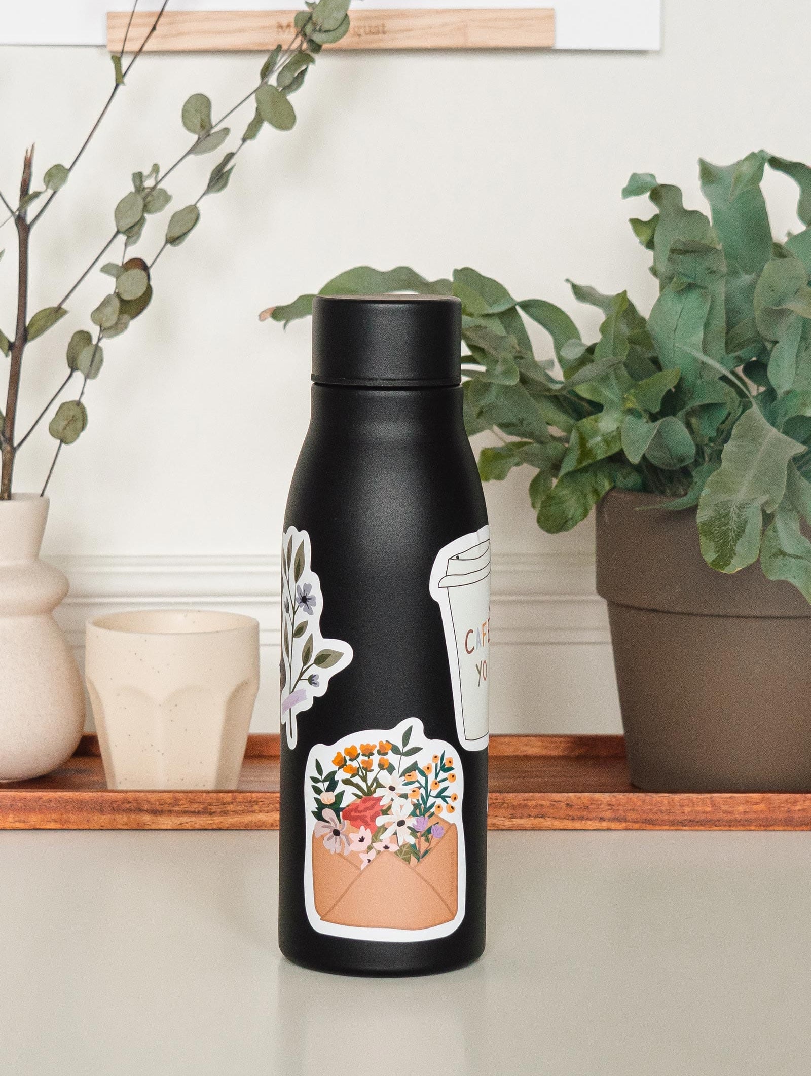 black water bottle with colorful floral sticker