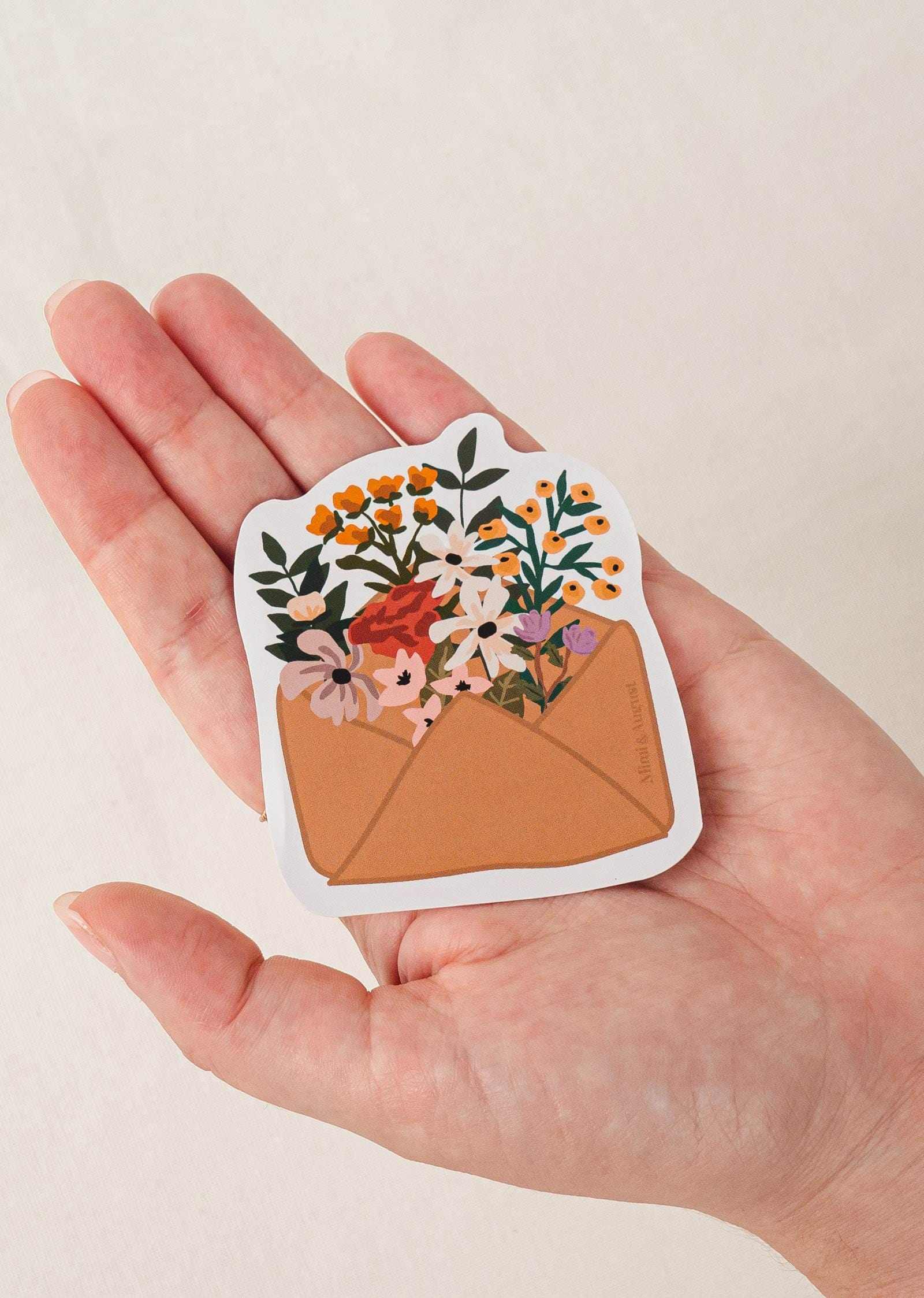 Flower Envelope vinyl sticker with colorful flowers in brown envelope held in hand