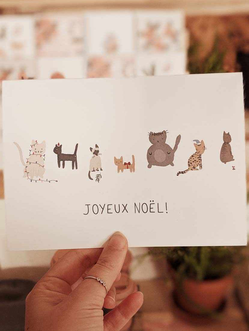 Joyeux Noël greeting card featuring illustrated cats on thick matte recycled paper with blank inside and white envelope.