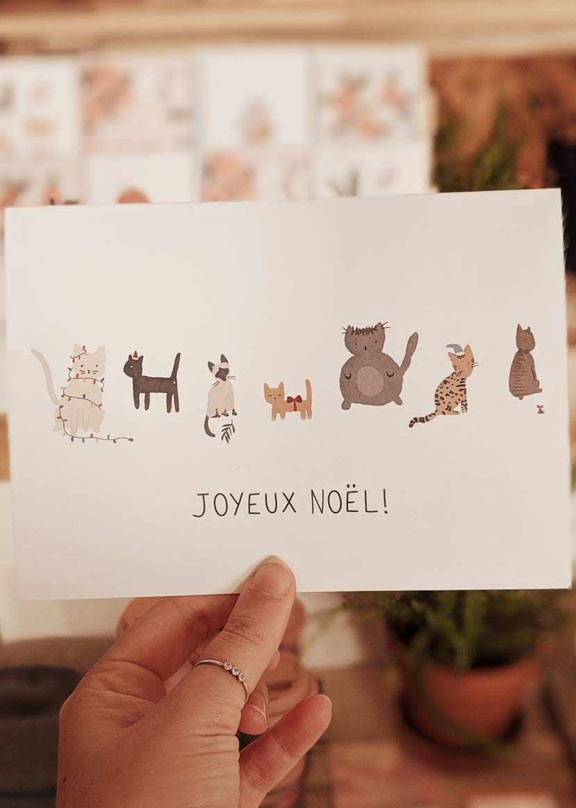 Joyeux Noël greeting card featuring illustrated cats on thick matte recycled paper with blank inside and white envelope.