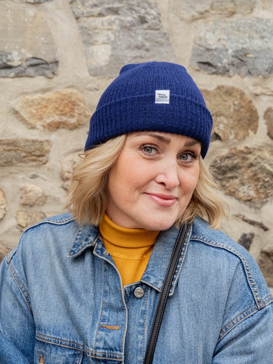 beautiful blond women wearing the blue sapphire beanie