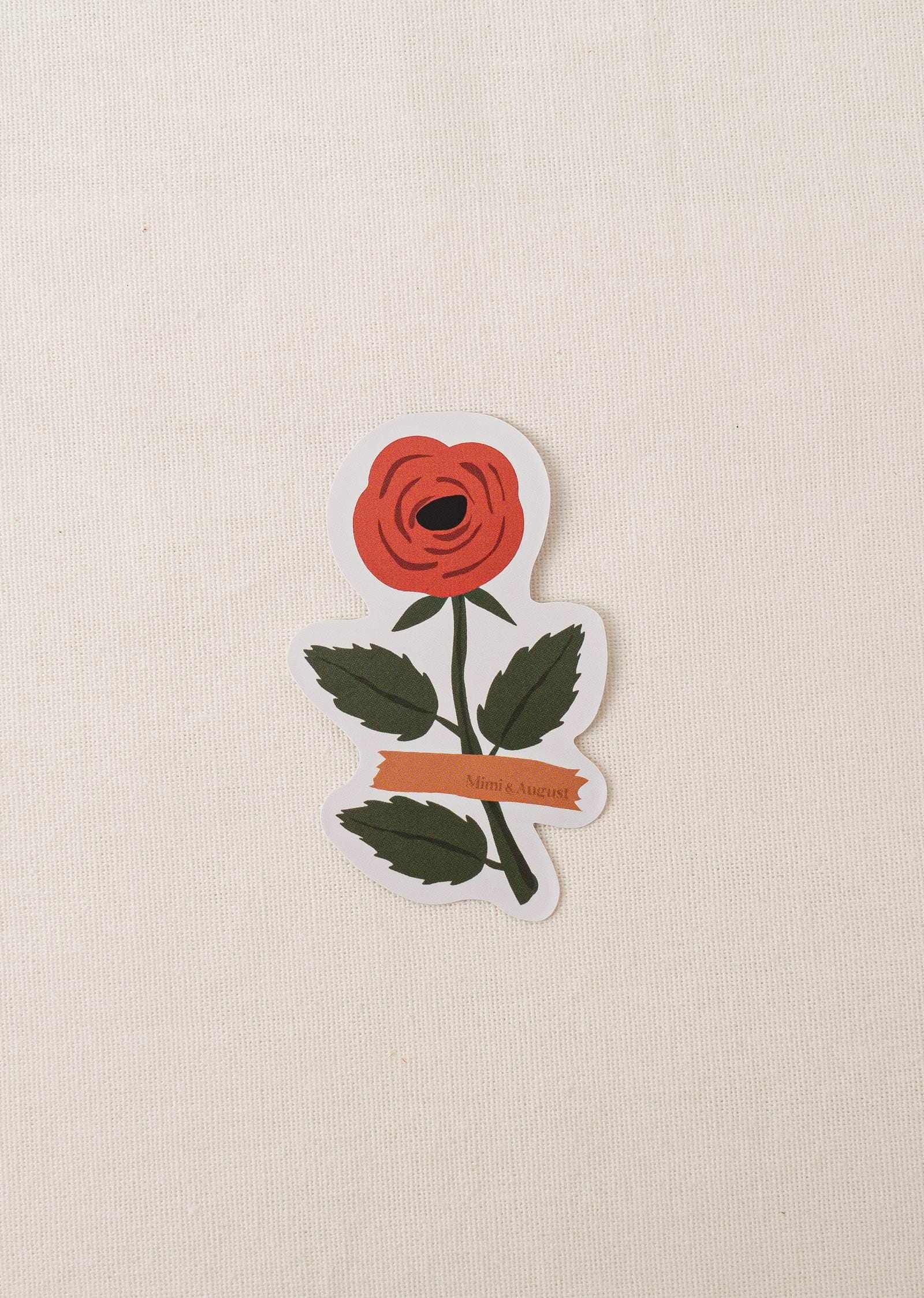Red rose vinyl sticker with white border on beige background