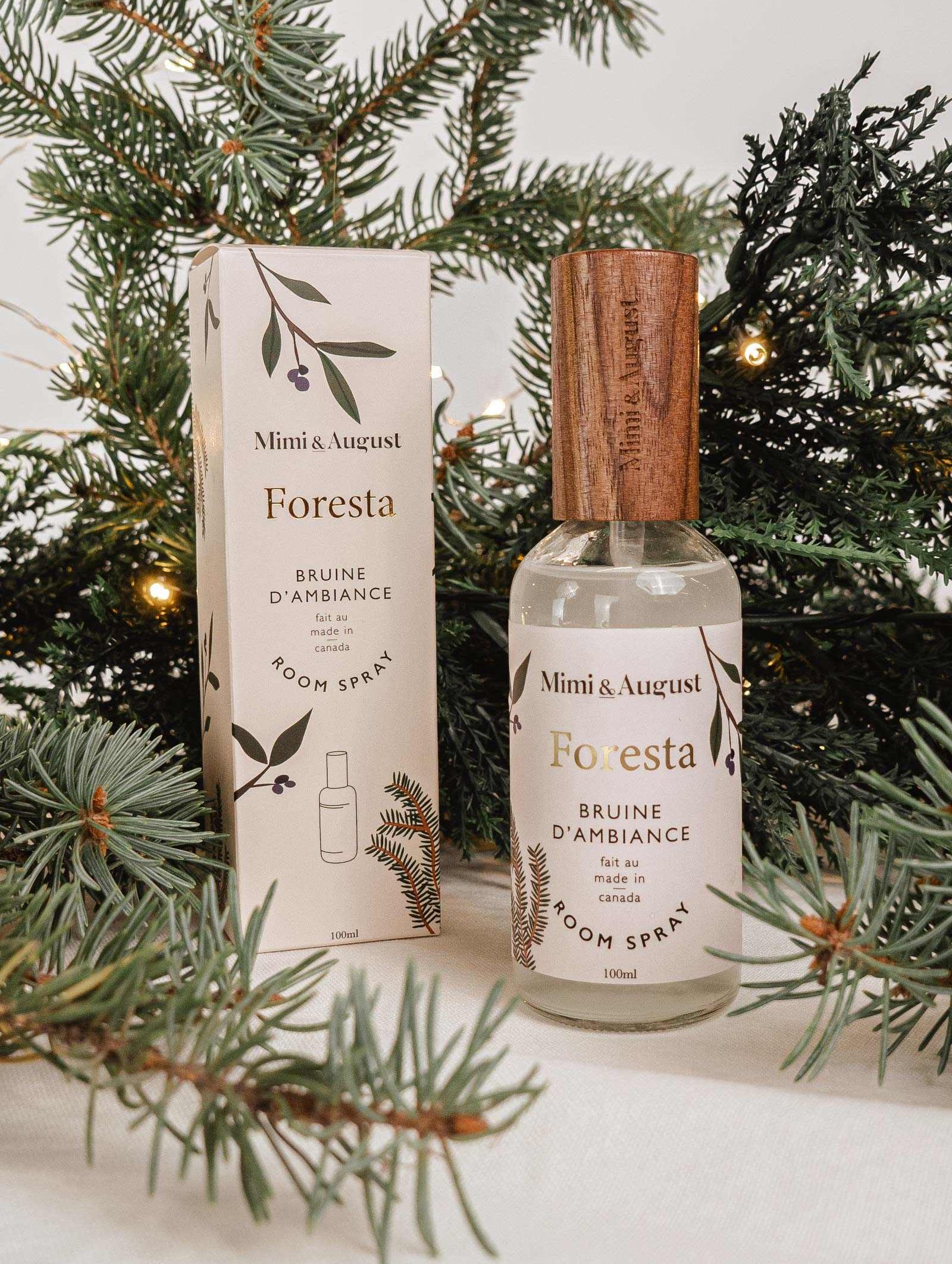 Forest room spray Foresta by Mimi & August with fir needle and cedarwood scent surrounded by evergreen branches