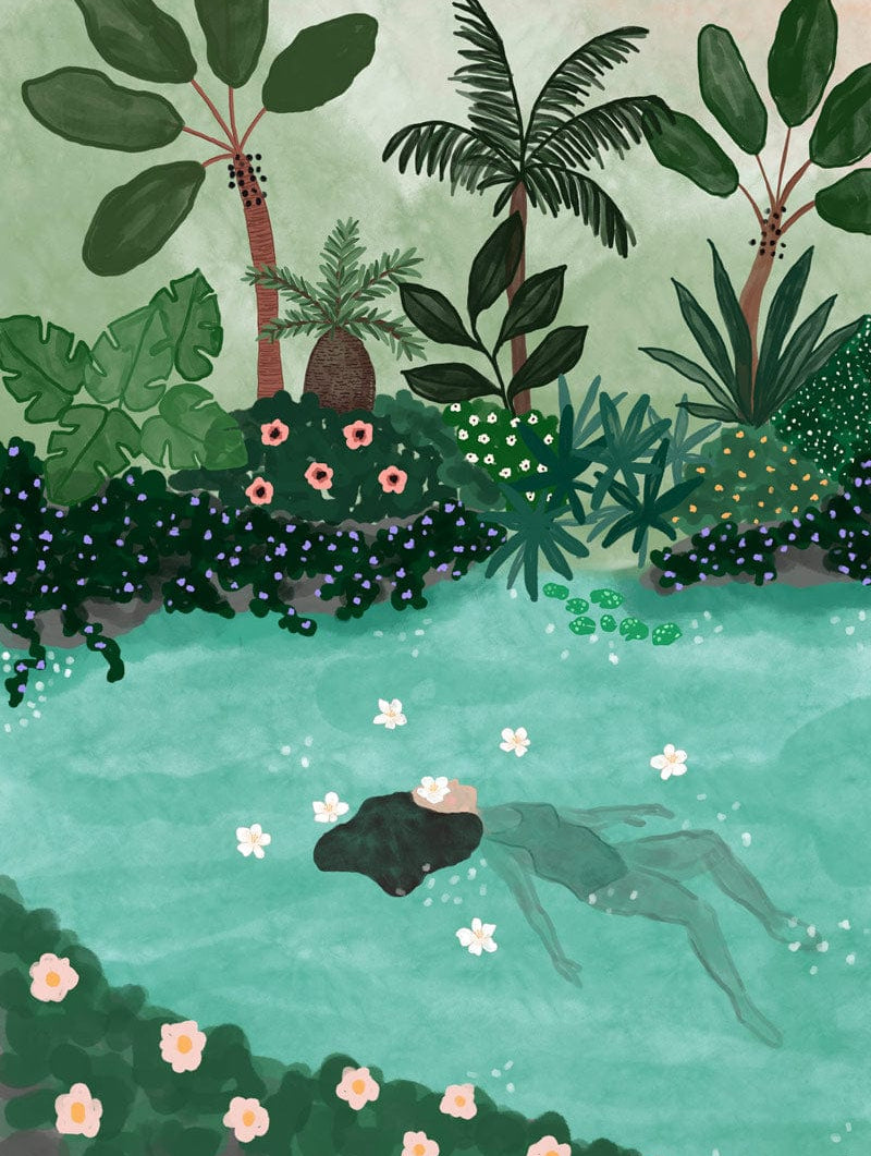 A person floats in a serene pool surrounded by lush tropical plants and flowers, with eco-friendly "Swimming in the Amazon Art Print" by Mimi & August featuring pink and white blossoms scattered on the water's surface.