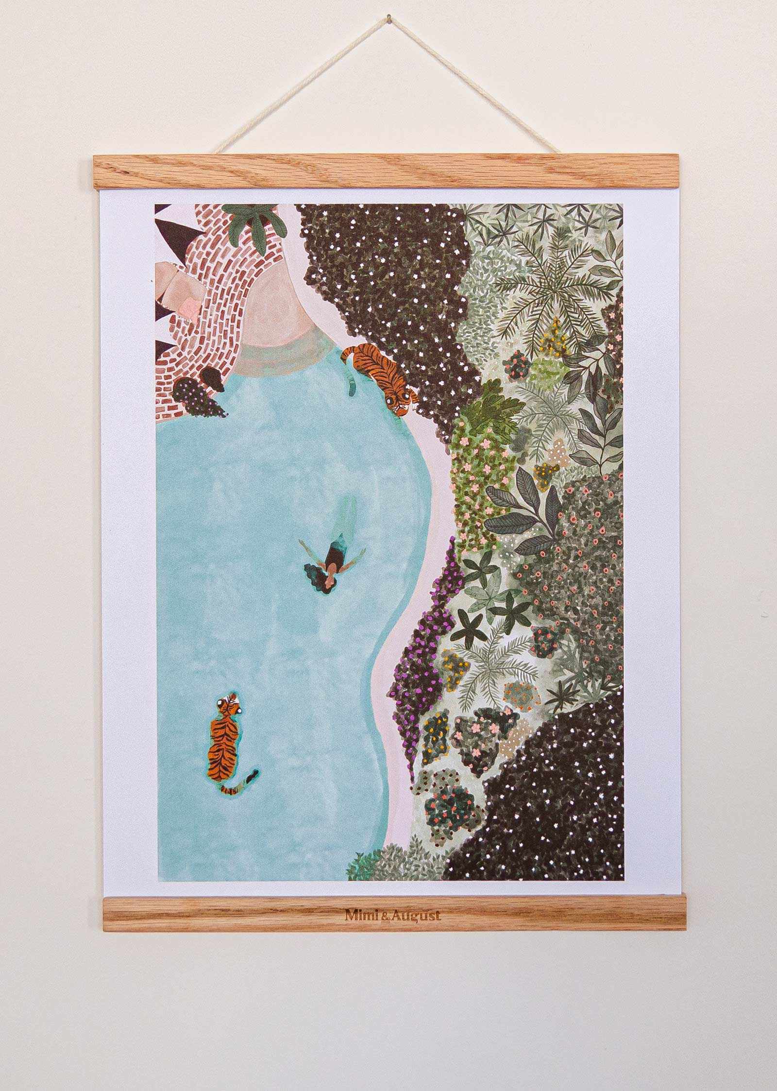 Swimming with Tigers Art Print hanging with wooden frame showing tiger swimming in blue water surrounded by lush greenery illustration
