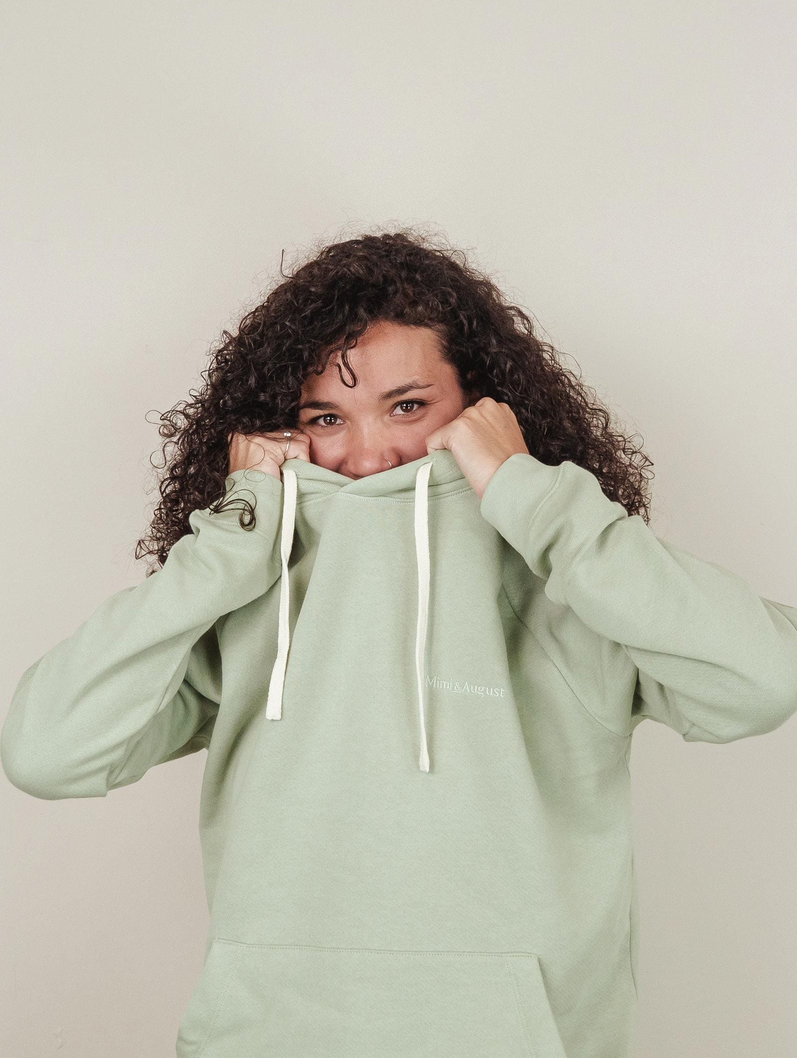 Melanie is wearing a size M agave hoodie by mimi and august