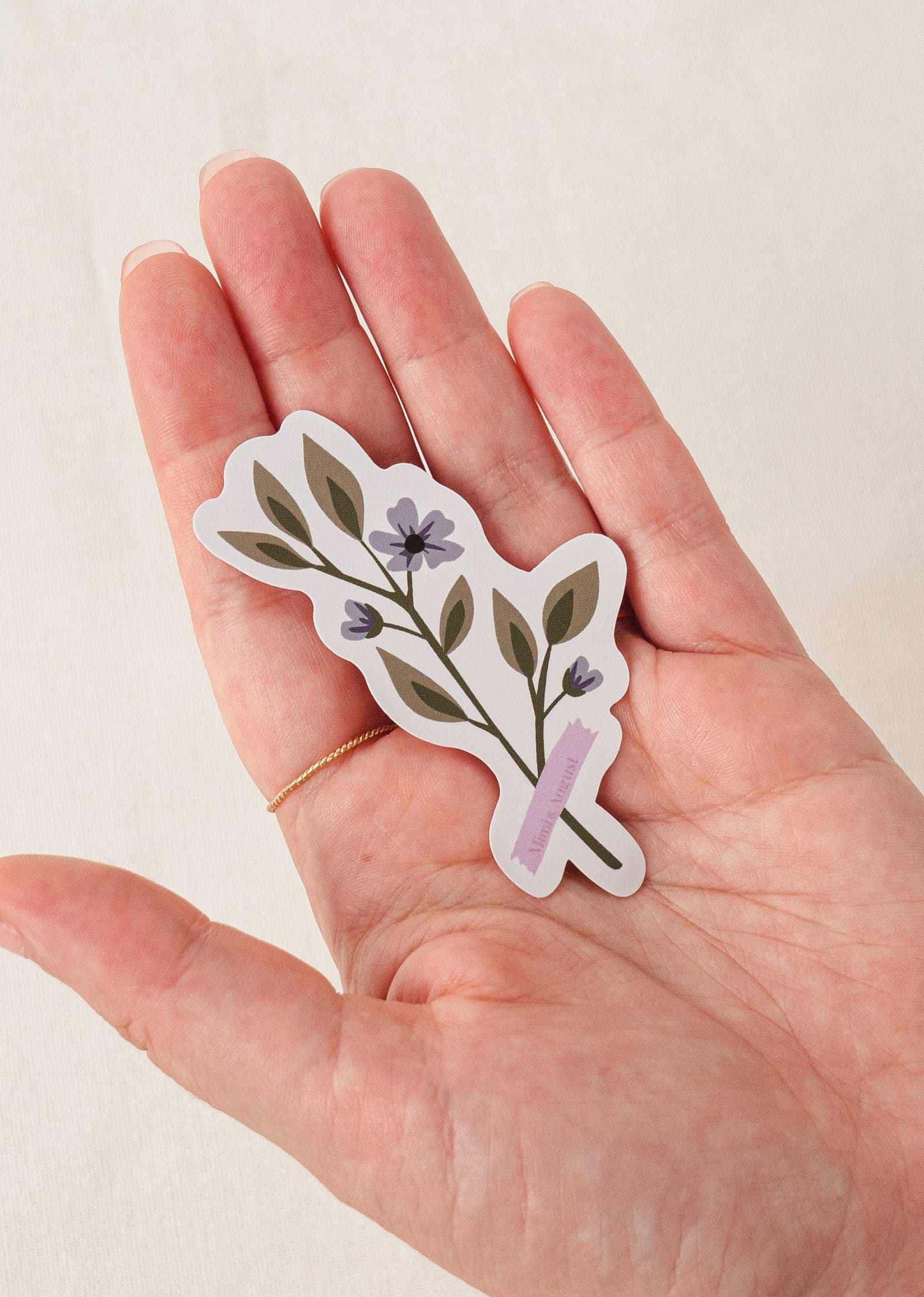 Balloon Flower vinyl sticker with purple flowers and green leaves in hand with white border and matte finish