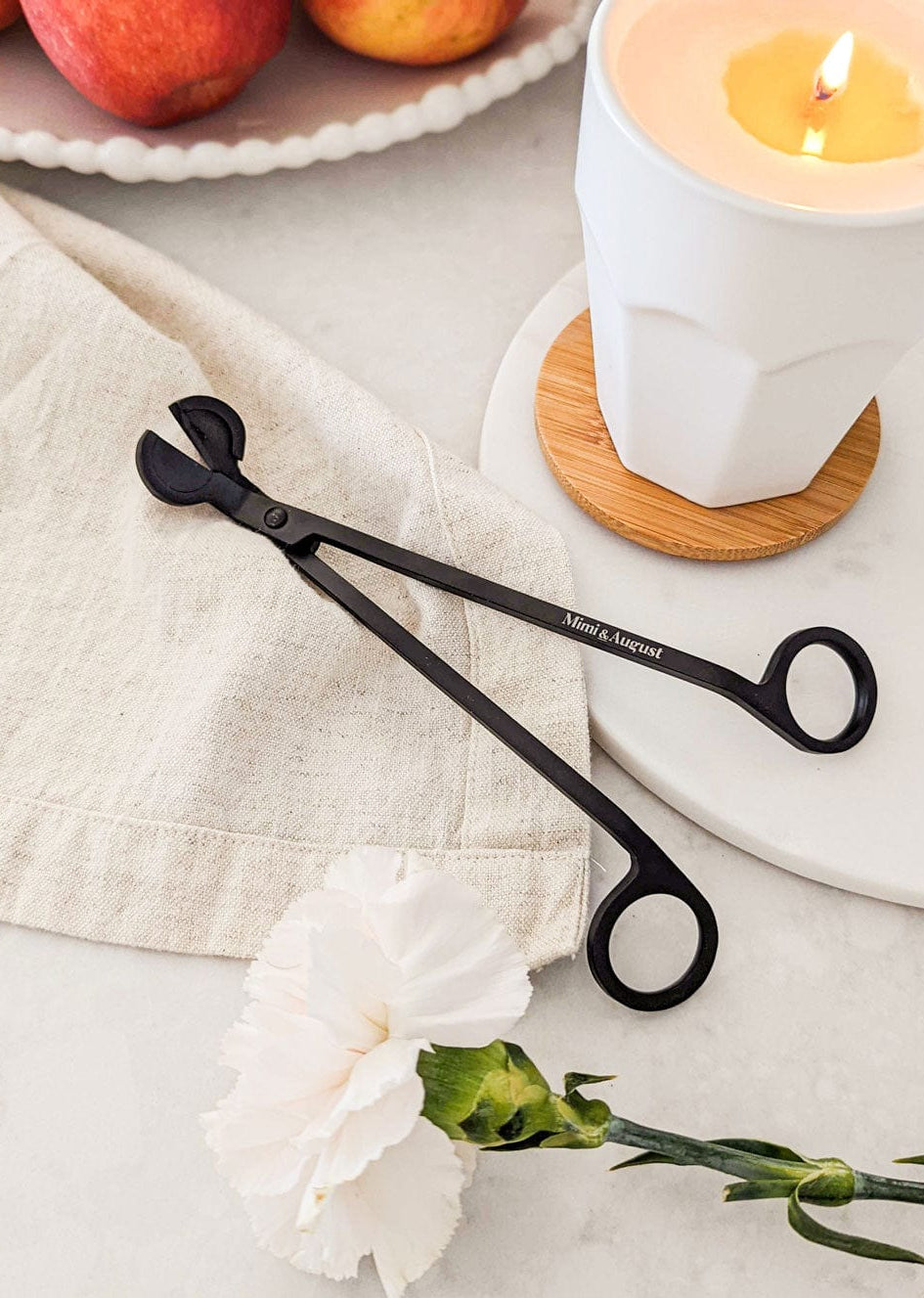 Black matte wick trimmer with Mimi & august engraved on it