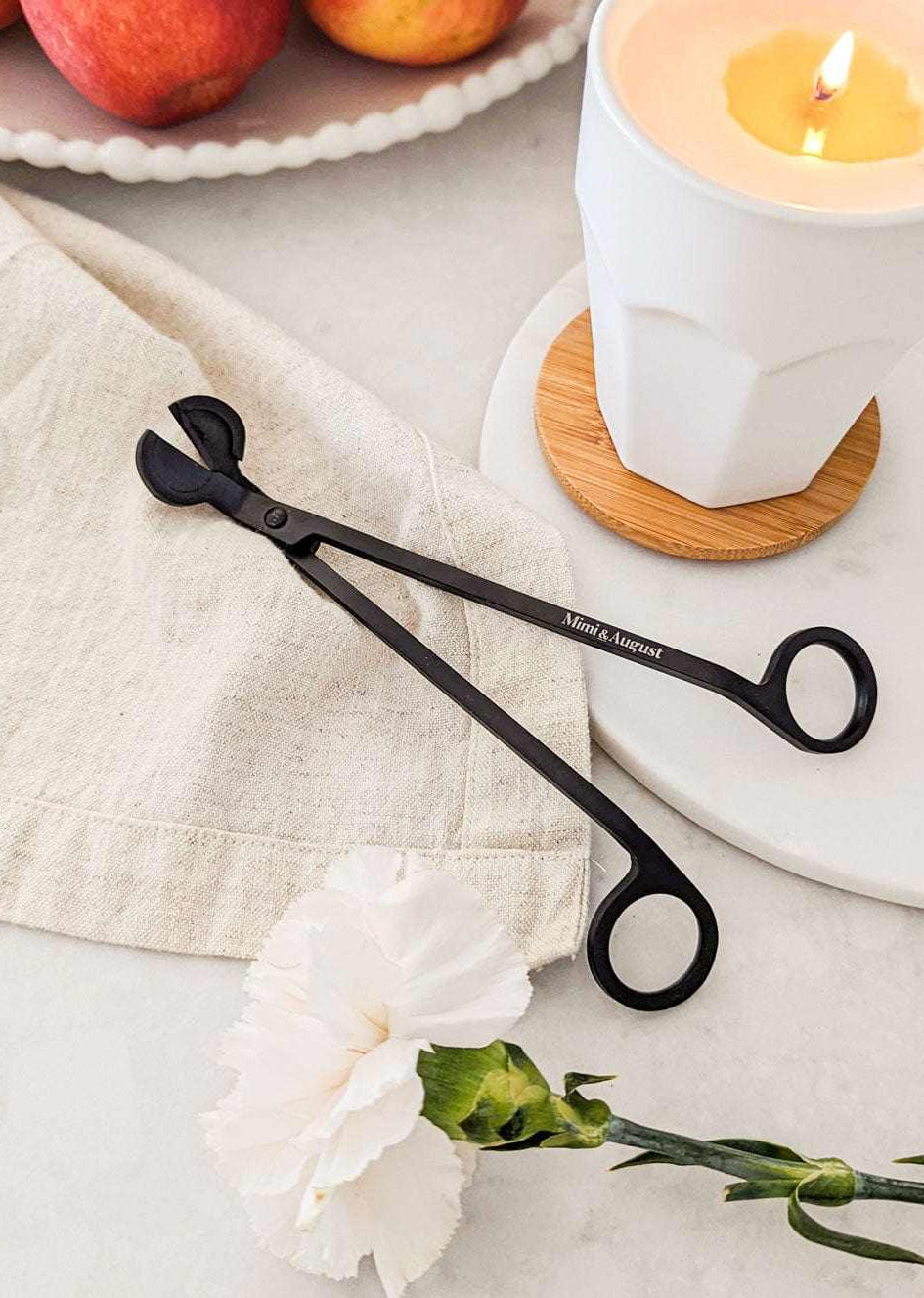 Black matte wick trimmer with Mimi & august engraved on it