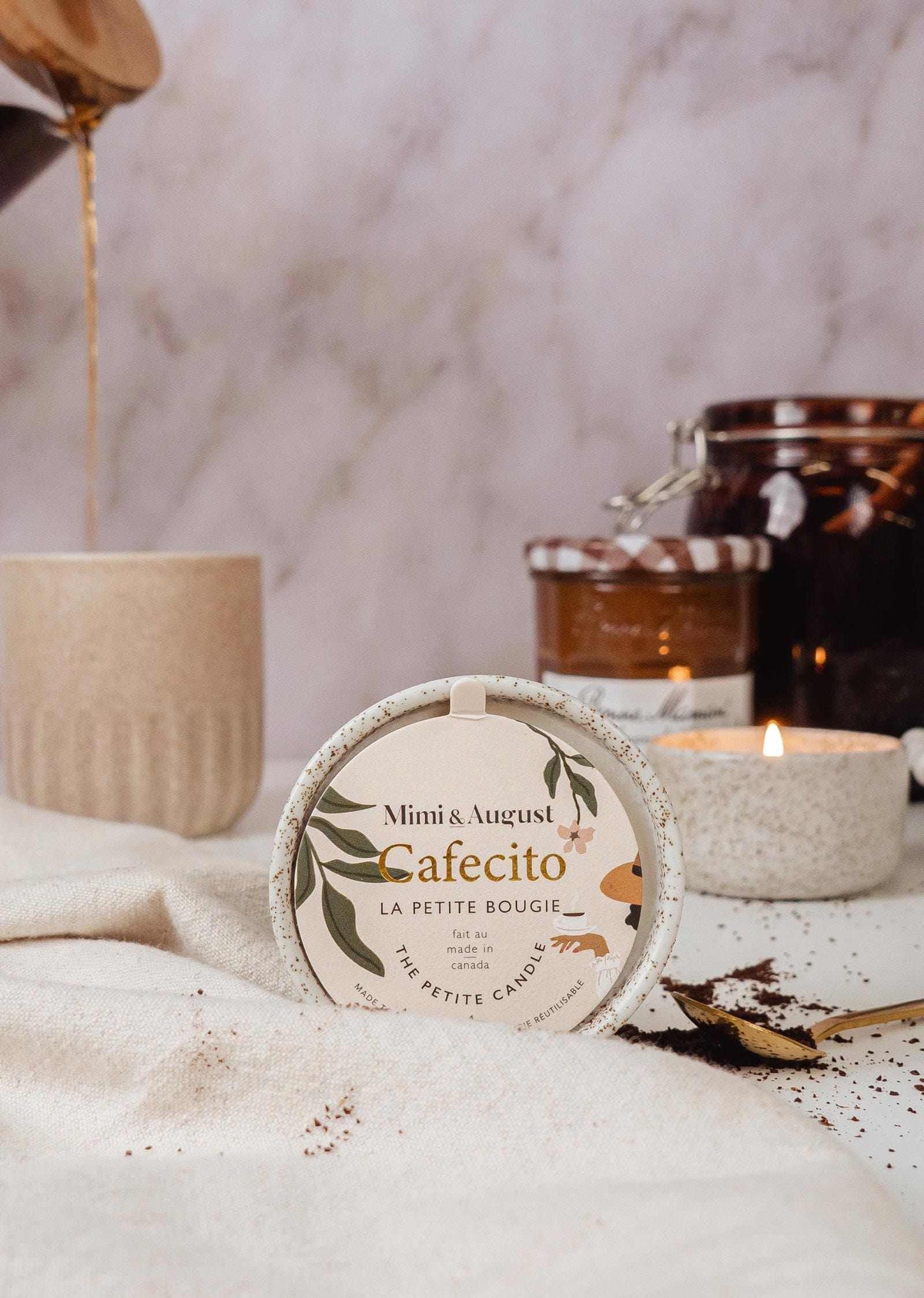 Cafecito reusable soy coffee candle with warm coffee, dulce de leche, and cacao scent in a ceramic cup and cozy setting
