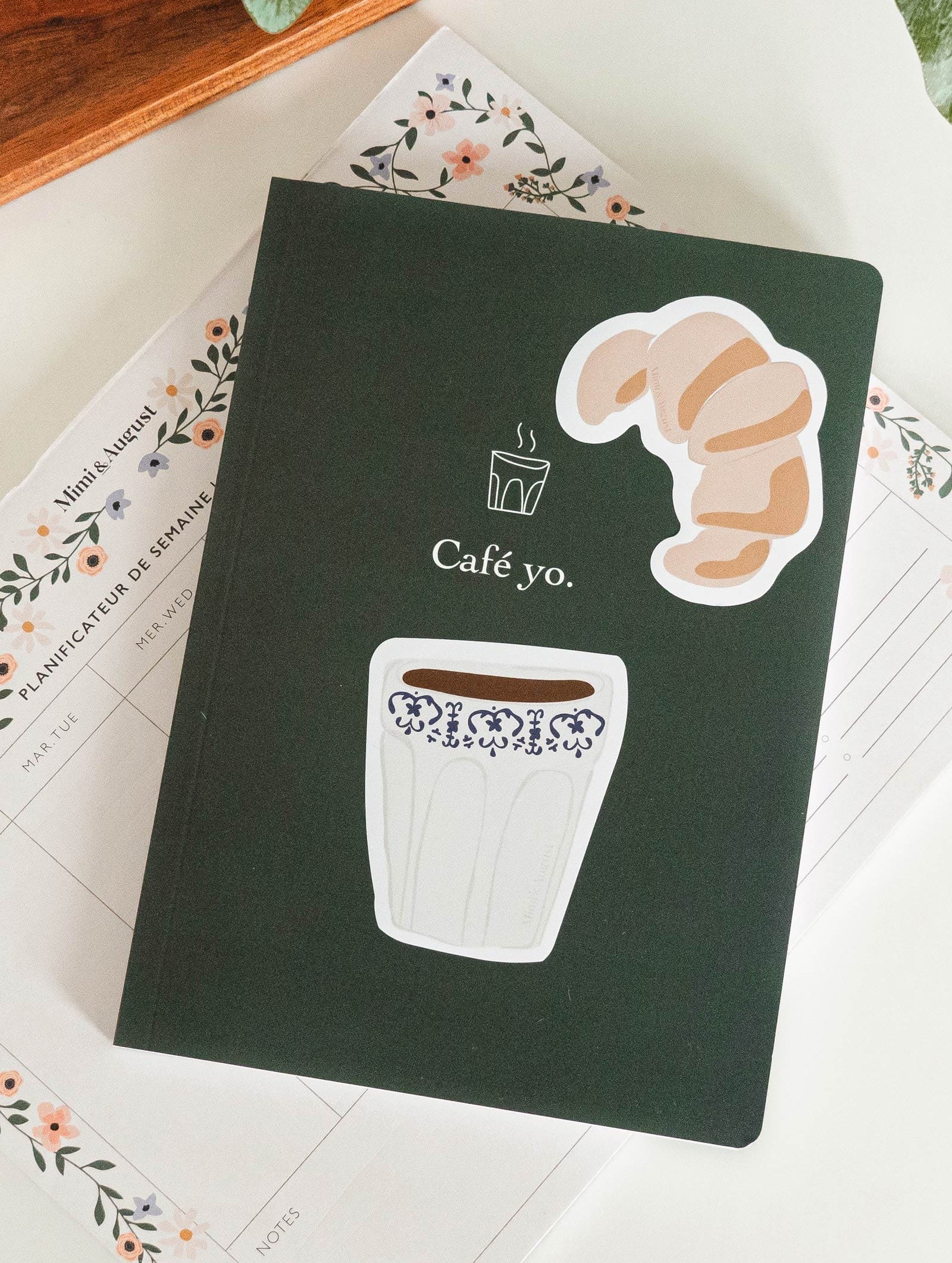 notebook with croissant sticker and coffee