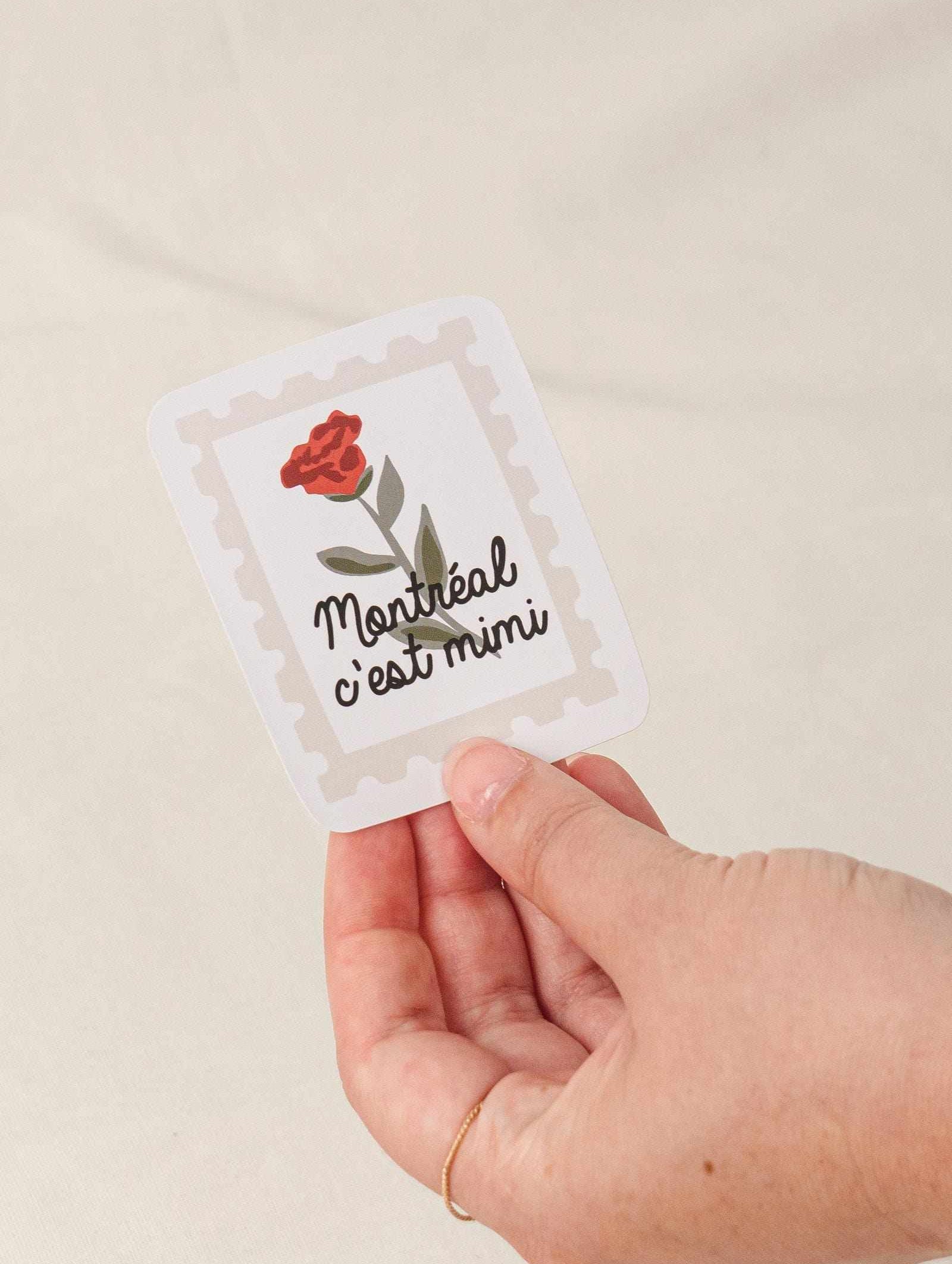 Flower Stamp - Vinyl Sticker with red flower and Montreal c'est mimi text held in hand with white border and matte finish