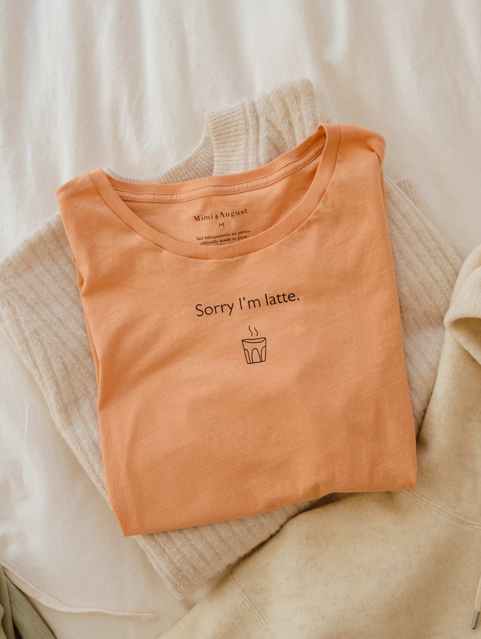 orange t-shirt with a humorous coffee quotes created by mimi and august