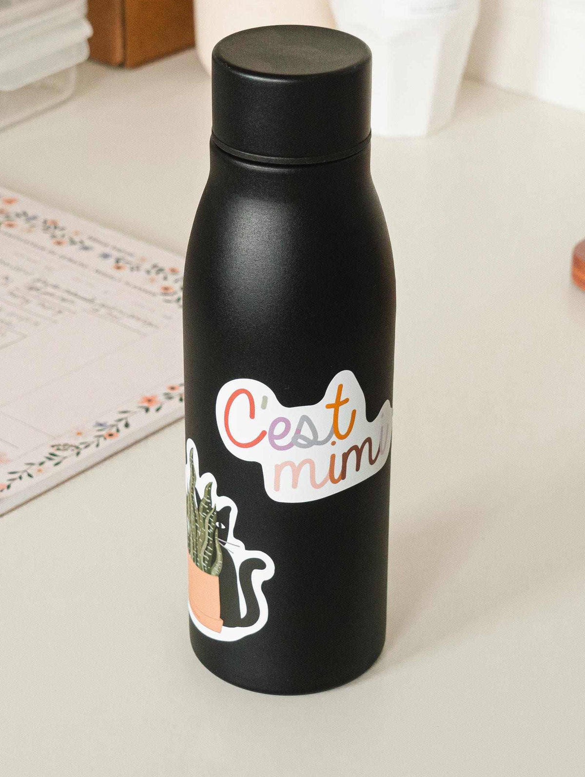 black water bottle with c'est mimi sticker