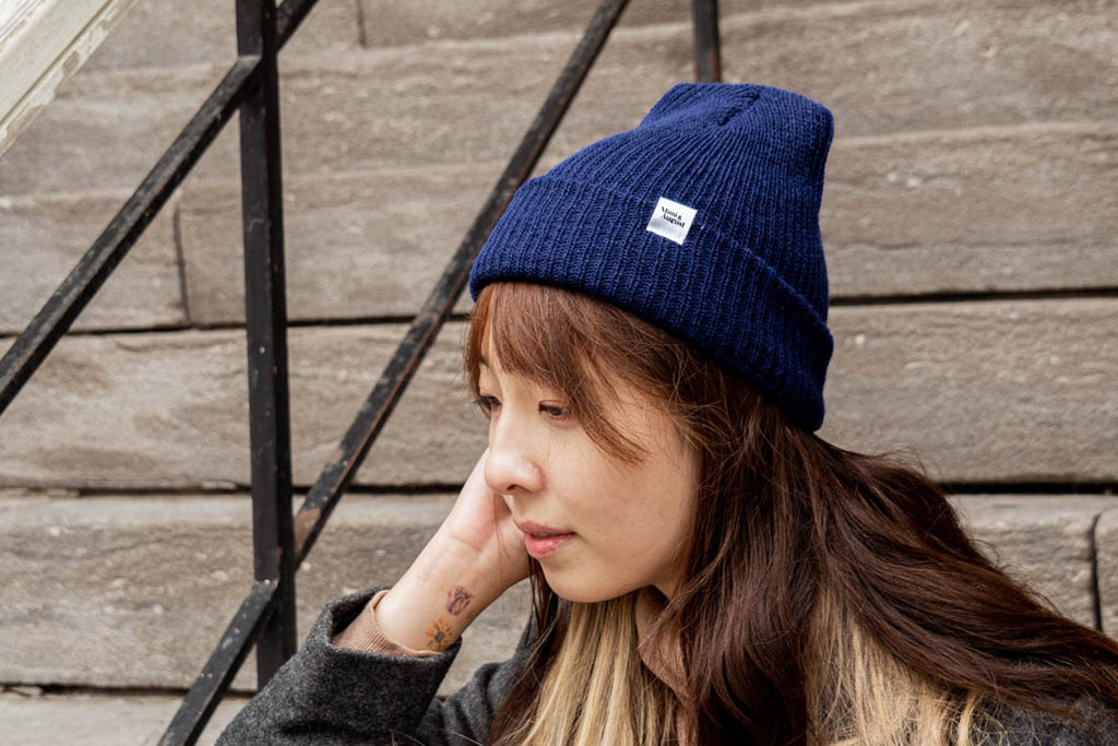 A young woman wearing a blue beanie.