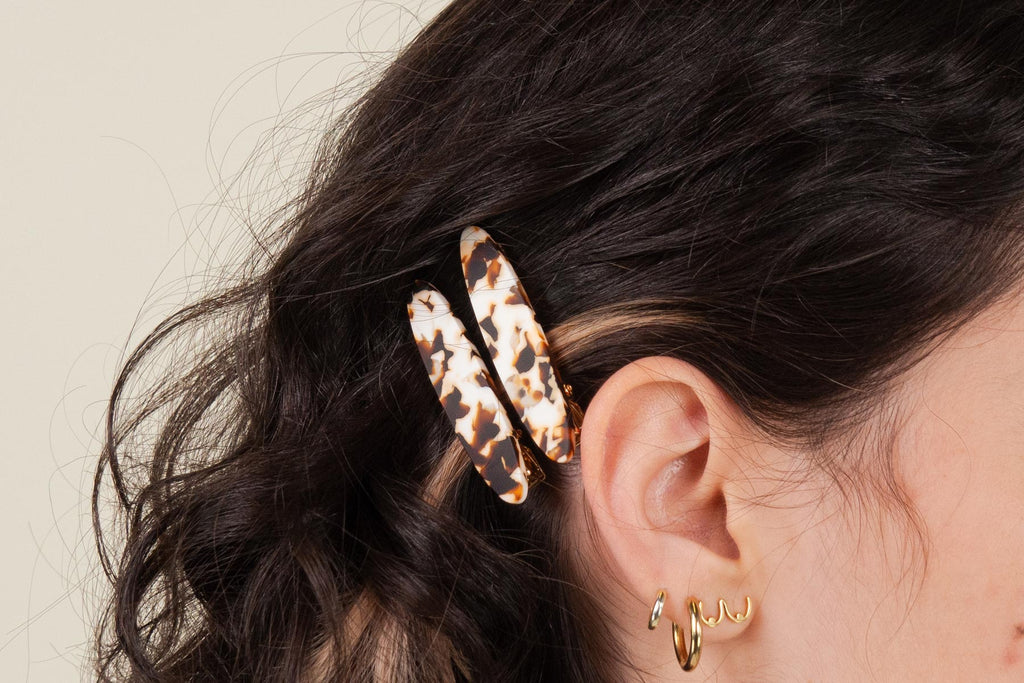 A woman wearing a leopard print hair clip.