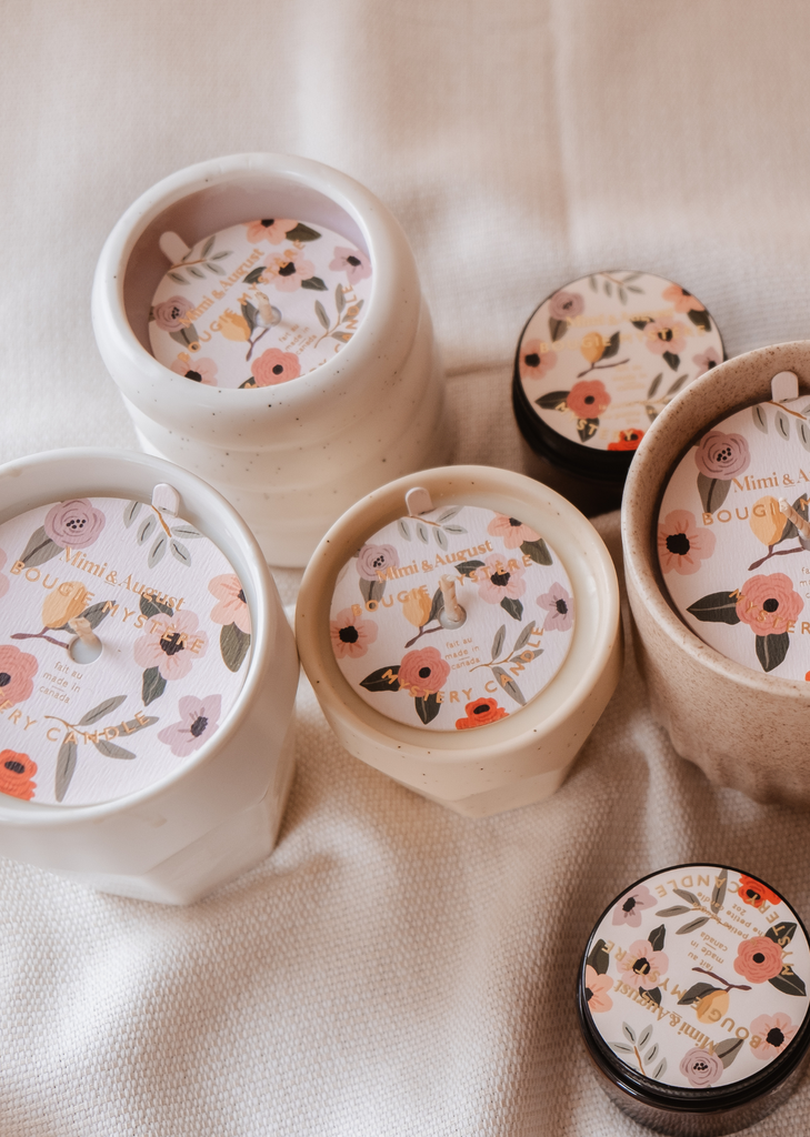 A set of Mystery Candles by Mimi & August, with enchanting floral designs, available in limited quantity.