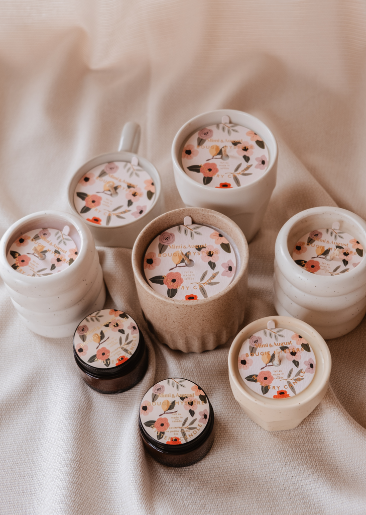 A set of Mystery Candle ceramic cups and bowls with limited quantity floral designs on them by Mimi & August.
