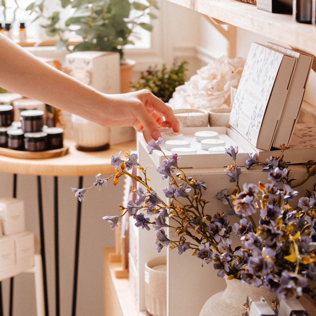Smelling a Mimi & August soy candle at the Longueuil boutique