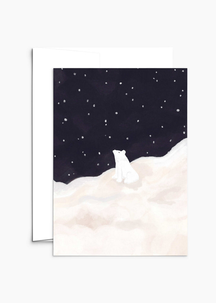 The "Bear-y Merry Wishes Under the Stars - Christmas Greeting Card" by Mimi & August features an illustration of a white polar bear sitting on a snowy hill beneath a starry night sky, ideal for Christmas greeting cards made from recycled paper.