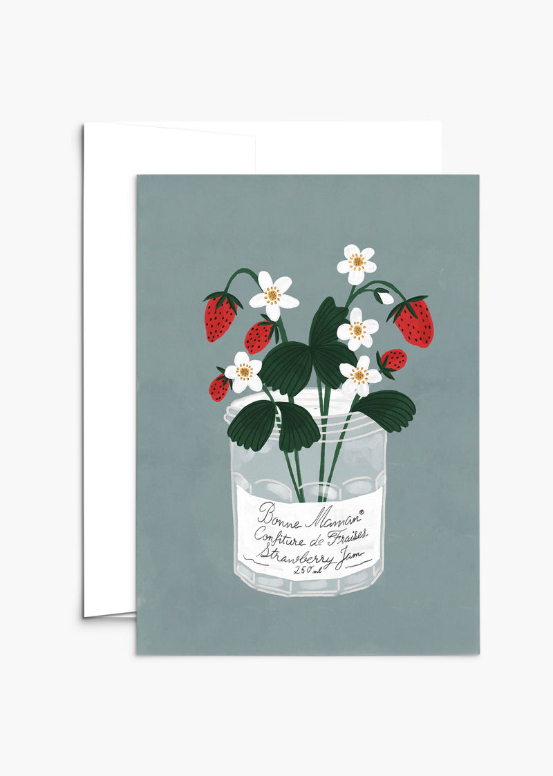 A Bonne Maman Mother's Day card featuring an illustration of a glass jar with strawberry plants, including both flowers and ripe strawberries, perfect for Mother's Day, against a gray background by Mimi & August.