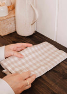 Soft linen tea towel drying dishes with natural texture and warm charm