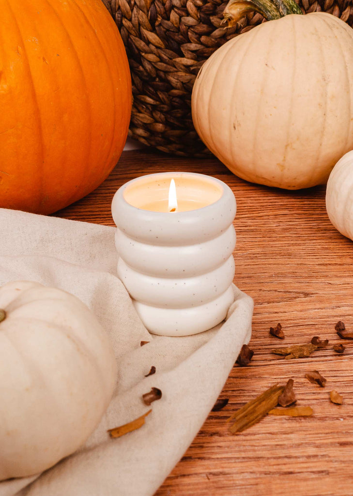 A Pumpkin candle 8 oz in a white ceramic mug made with soy wax by mimi and august