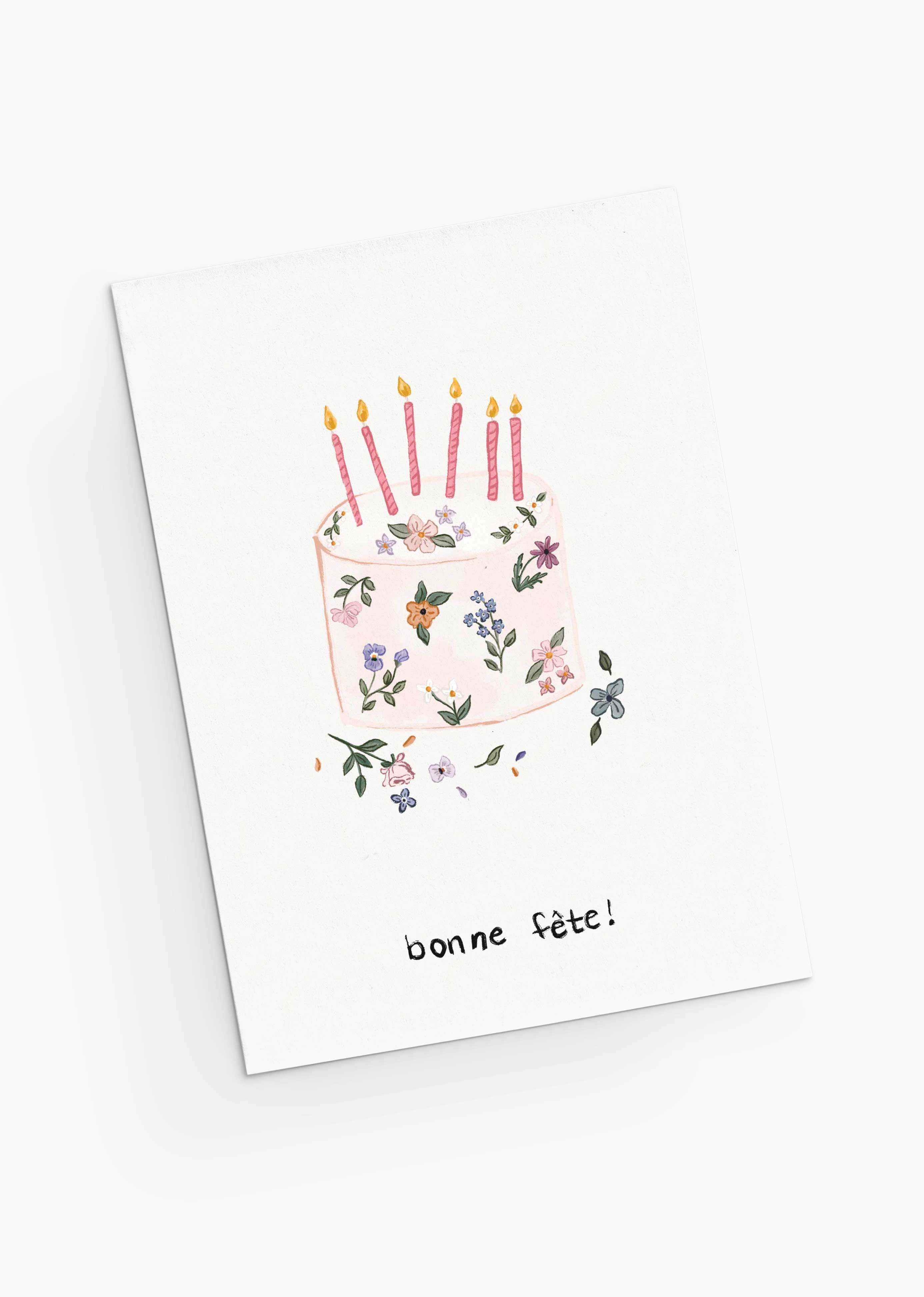 The Mimi & August Floral Birthday Cake Greeting Card features hand-drawn flowers in a cake design with five lit candles and "bonne fête!" below, printed on recycled paper.