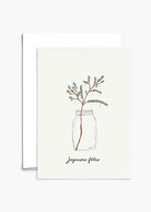 The Mimi & August Christmas Tree Branch Greeting Card is printed on recycled paper, features a simple pine branch in a jar with "Joyeuses fêtes" below, and is blank inside for your personal message.