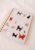 The Kittens - Agenda 2025 by Mimi & August features a sturdy cover decorated with illustrations of cats, spiral binding, and convenient monthly tabs for effortless organization.