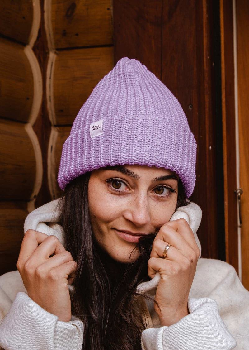 A woman wearing a Lilac Chunky Beanie by mimi and august.