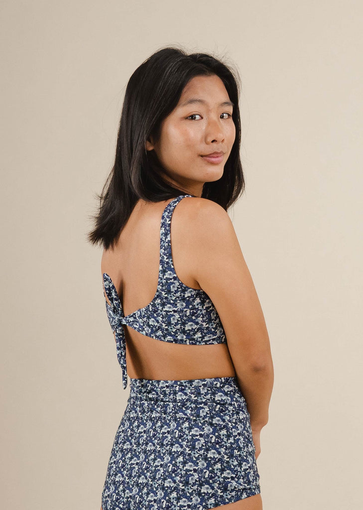 A asian woman in a Lima Moonflower Bralette Bikini Top with an adjustable knot.